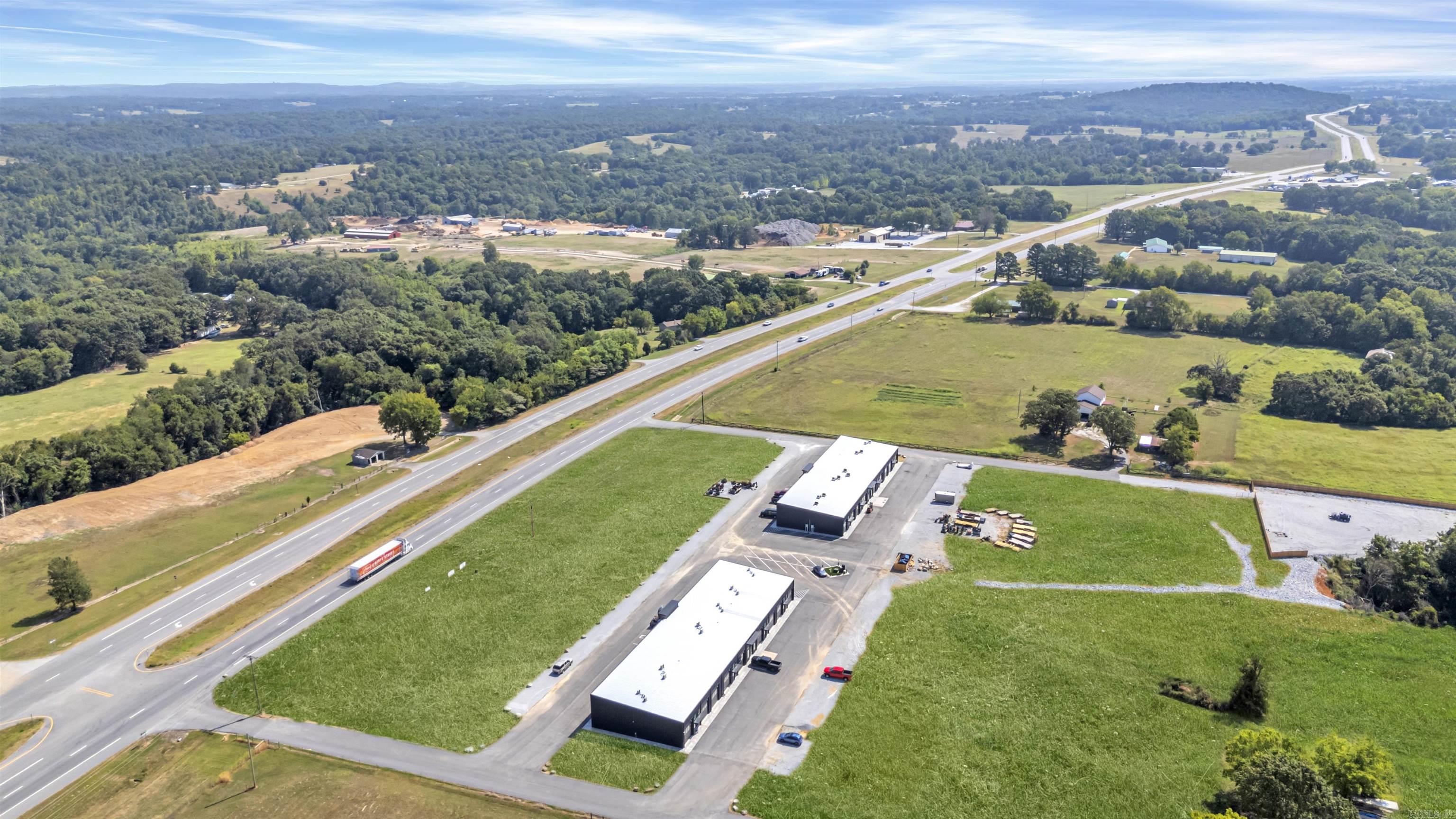Two multi tenant NNN flex space centers in east Springdale, Arkansas is available for acquisition. The two buildings each total 11,998 square feet (23,996 SF in total) and combined are currently 84% leased, with four suites available for lease up. All tenants operate under NNN leases with minimal landlord responsibilities. The current rent is $279,660 with 19 tenants but there is a potential rent of $333,660, if the 4 vacant units are filled at their listed rates. The adjusted NOI is $320,844, when considering the vacant units. The site spans 5 acres and sits along Highway 412 with approximately 19,000 vehicles per day.