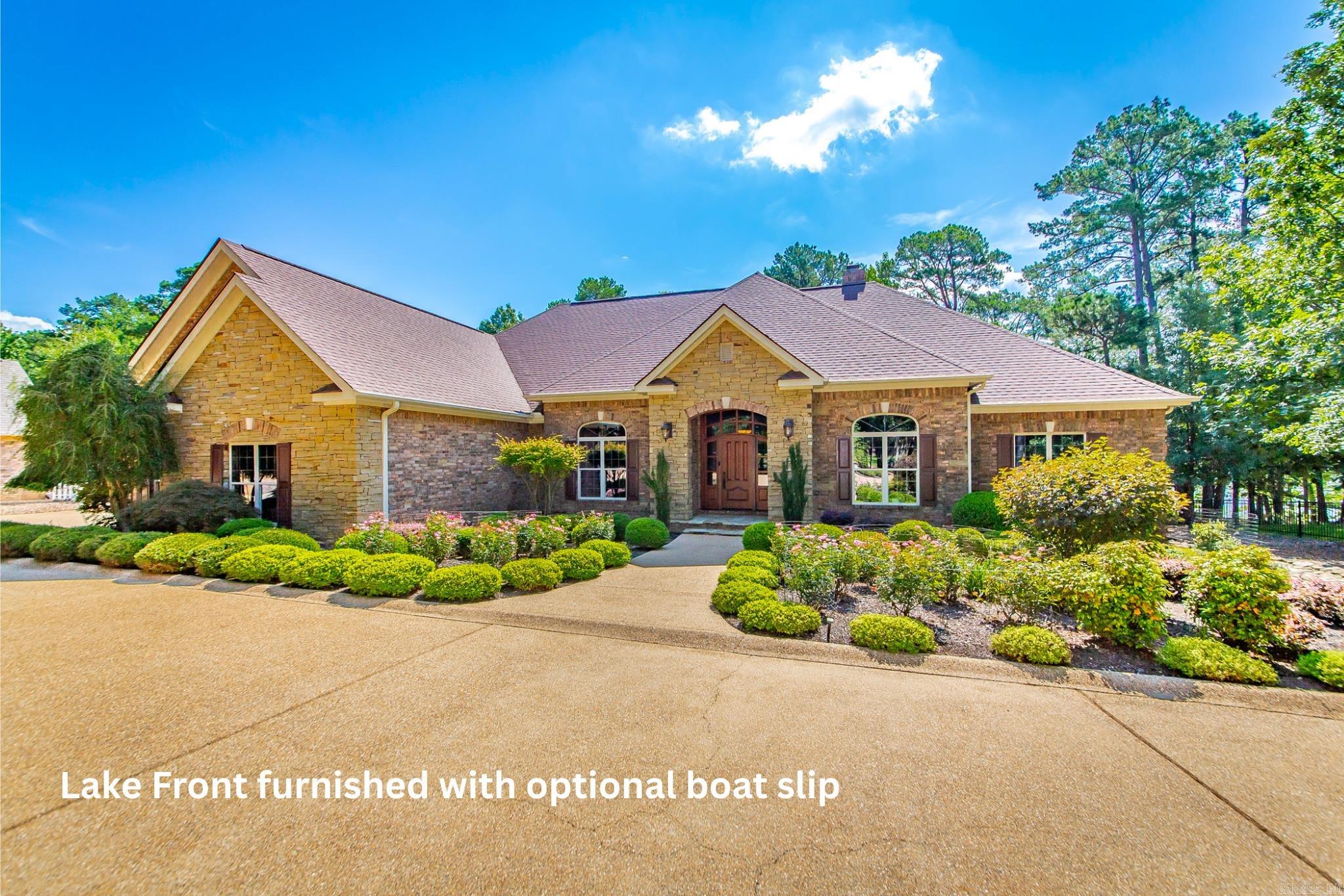 Experience the pinnacle of lakefront luxury in this furnished masterfully crafted home, designed with meticulous attention to every detail. Enjoy the ultimate waterfront lifestyle, a deeded boat slip in Grand Isle Dock—featuring a new lift for your convenience is also available for purchase. Custom alder wood cabinetry graces the kitchen & bathrooms. Imported Brazilian interior doors & a striking custom-built mahogany front entrance welcome you in style. Two primary suites offer privacy & comfort, while a bonus room upstairs serves perfectly as a den, home theater, or bedroom. The existing half-bath can be easily expanded to a full bath. Enjoy high-end appliances, including a built-in Miele coffee machine. The walk-in wine cellar is temperature controlled—a Wine Connoisseur's dream. Every interior wall is insulated for superior quiet & energy efficiency, 2 lifetime warranty water heaters ensure a worry-free experience. Oversized two-car garage plus a separate attached garage/workshop. Enjoy comfort & efficiency w/ the brand new dual zone geothermal HVAC unit. New high-end composite decking & railing. See Agent remarks. Relax & entertain overlooking Greers Ferry Lake.