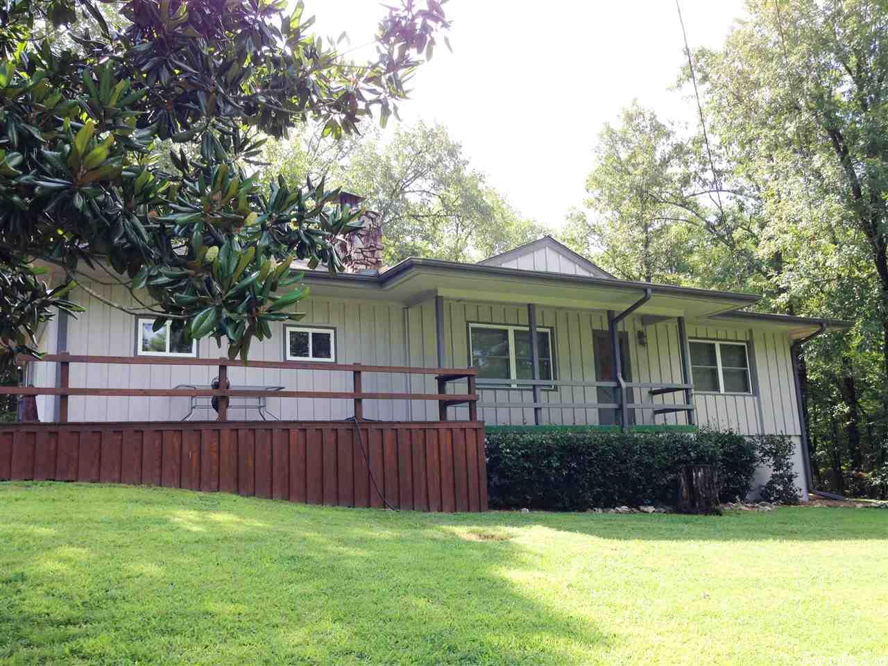 Great location-Cedar sided 2 bedroom 1 1/2 bath home with attached garage & screen porch! Native stone fireplace with gas logs. New 1050 gallon septic tank 2015! Central heat & air. Nice kitchen, tiled floor, with all appliances included in listing price, also washer & dryer stay! Living room features native stone fireplace with gas logs, also very pretty laminate flooring. 2 bedrooms (one is quite large) 1 1/2 bathrooms- nice deck outside - great private yard! #1989