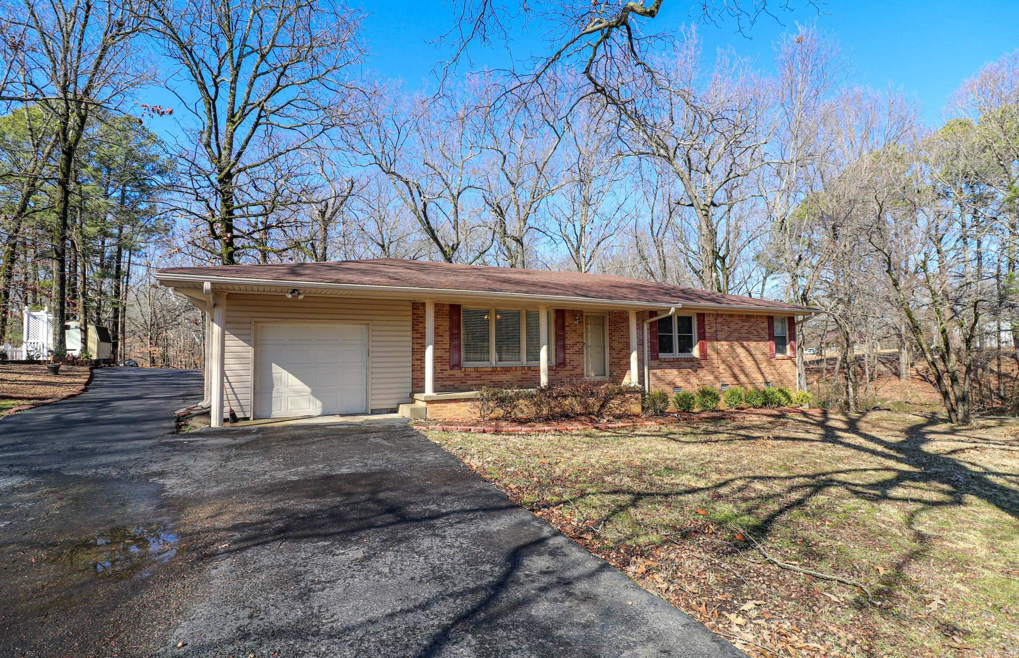 2.4 acres surround this well maintained one owner brick home just outside the Jonesboro city limits. Remodeled kitchen with granite countertops, newer appliances including refrigerator, breakfast bar and custom white cabinets. Formal living/dining room, cozy den with wood beams, brick wall and gas fireplace complete the two main living areas. Plus an additional sunroom enclosed with beautiful windows for a view of the over two acre backyard. A bedroom wall has been removed to make an extra large main bedroom but could be reinstalled to make a three bedroom home if needed. Both bathrooms are spacious and updated. 24 X 24 (approximately) shop building with electricity.