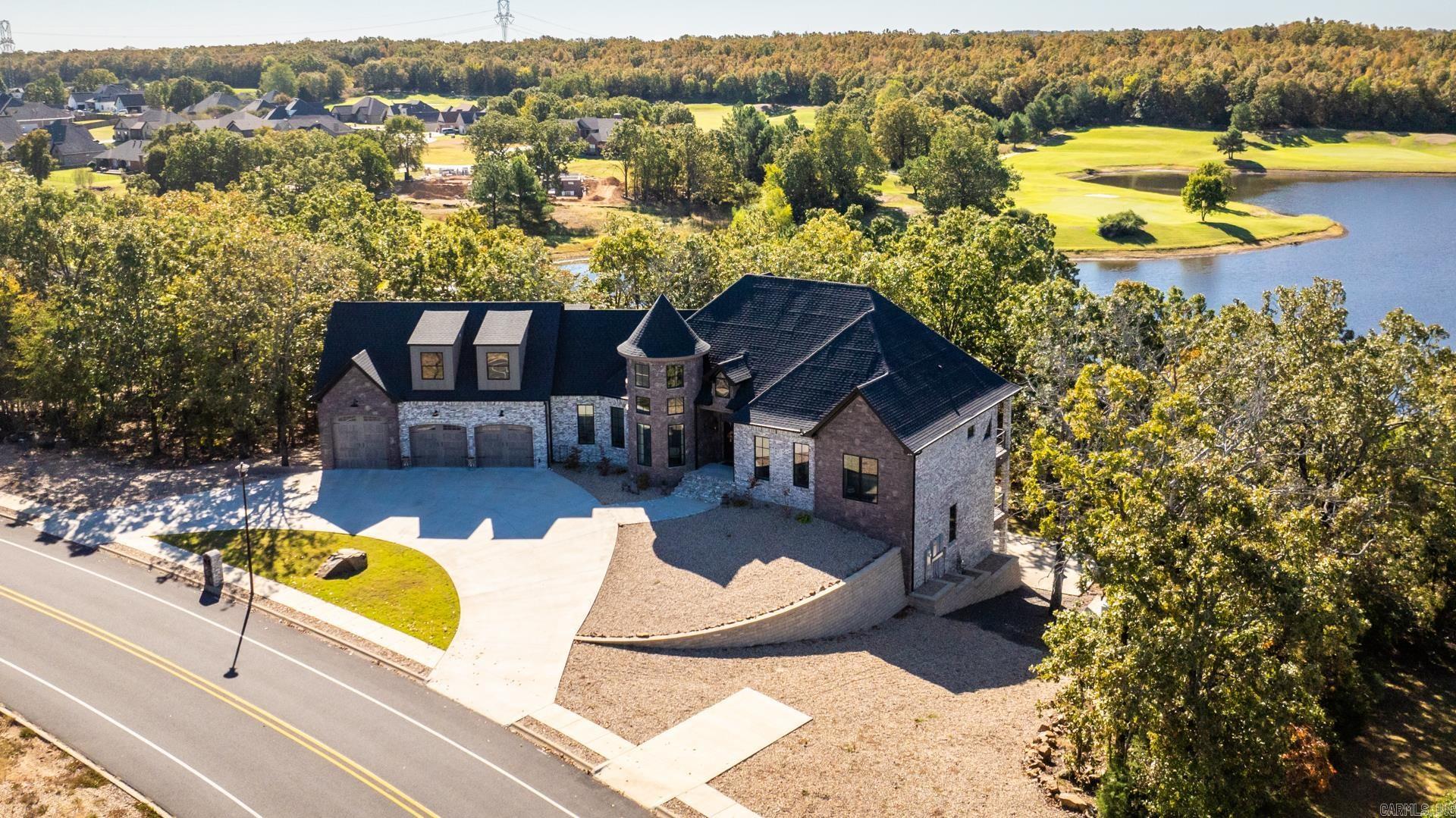 Cost to build 1.9Million, instant equity. Lake View! Discover a luxurious Fox Block concrete home featuring exceptional R-50 insulation timber beam framing, and foam insulation for energy efficiency. Highlights include a fully conditioned attic, an immersive home theater with a 120" screen and Dolby Atmos sound, custom chandeliers, and a modern fireplace with unique brickwork. The gourmet kitchen boasts state-of-the-art Café GE appliances, ice machine, a pot filler, and custom vintage cabinets. Enjoy a golf simulator, a whole-house generator, and a water conditioner for added luxury. The spacious 3-car garage includes an RV door, workshop, and is climate-controlled. This home, nominated for ICF House of the Year, combines luxury, comfort, and innovation seamlessly. Closet features island, chandelier, and cedar coat area. Home located on 11th fairway green of Cypress Creek Golf Course. Dog grooming room. See associate documents for upgrade lists and more details.