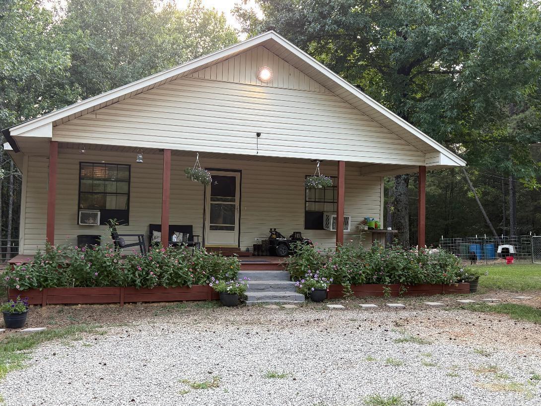This Charming 2 Bedroom 1 Bath home sits on 3 beautiful acres surrounded by beautiful trees. The Living Room Features a Vaulted Ceiling and open Living Room and Kitchen. Kitchen Features a Nice Pantry and a New Refrigerator, Garbage Disposal, New Hot Water heater and Dishwasher is 2 years old. New Flooring in hallway and Bathroom and Bedrooms. All New Paint throughout the Home. Covered Front Porch and Back Porch leading to a fenced in Animal Pens. The road frontage of Property features a Horse Pasture currently featuring water for animals and lights. Chicken Coop and All Animal pens will convey with property, and Storage Building will convey and has electricity. See Agent Remarks.