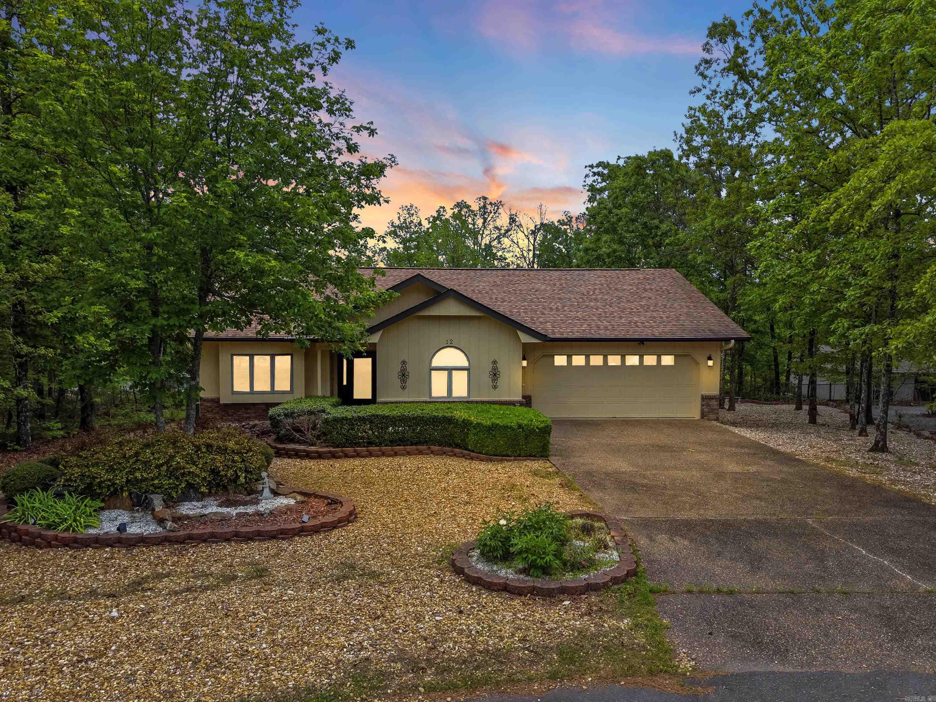 Tucked away at the end of a quiet cul-de-sac, this home includes the lot next door for added privacy and room to breathe. Step inside to a light-filled living room with vaulted ceilings and a cozy gas log fireplace that opens seamlessly to a partially covered back deck, perfect for relaxing or entertaining year-round. The dining area features an elegant tray ceiling and a charming bay window that fills the space with natural light. The well-designed kitchen offers ample cabinetry, generous counter space, and a walk-in pantry. The primary suite is a true retreat with a walk-in closet plus a bonus closet for extra storage. This home has been lovingly maintained and thoughtfully updated, with fresh interior and exterior paint, Andersen windows, a 7-year-old Lennox heat pump, a 7-year-old roof, and newer gutter guards in the back. Move-in ready, inside and out. Life in Hot Springs Village means access to world-class amenities, including 9 golf courses, 11 lakes, pickleball, hiking trails, a white sand beach, tennis, a fitness center, and both indoor and outdoor pools. All just 30 minutes from Hot Springs or Benton, and one hour from the Little Rock airport. *Photos are virtually staged