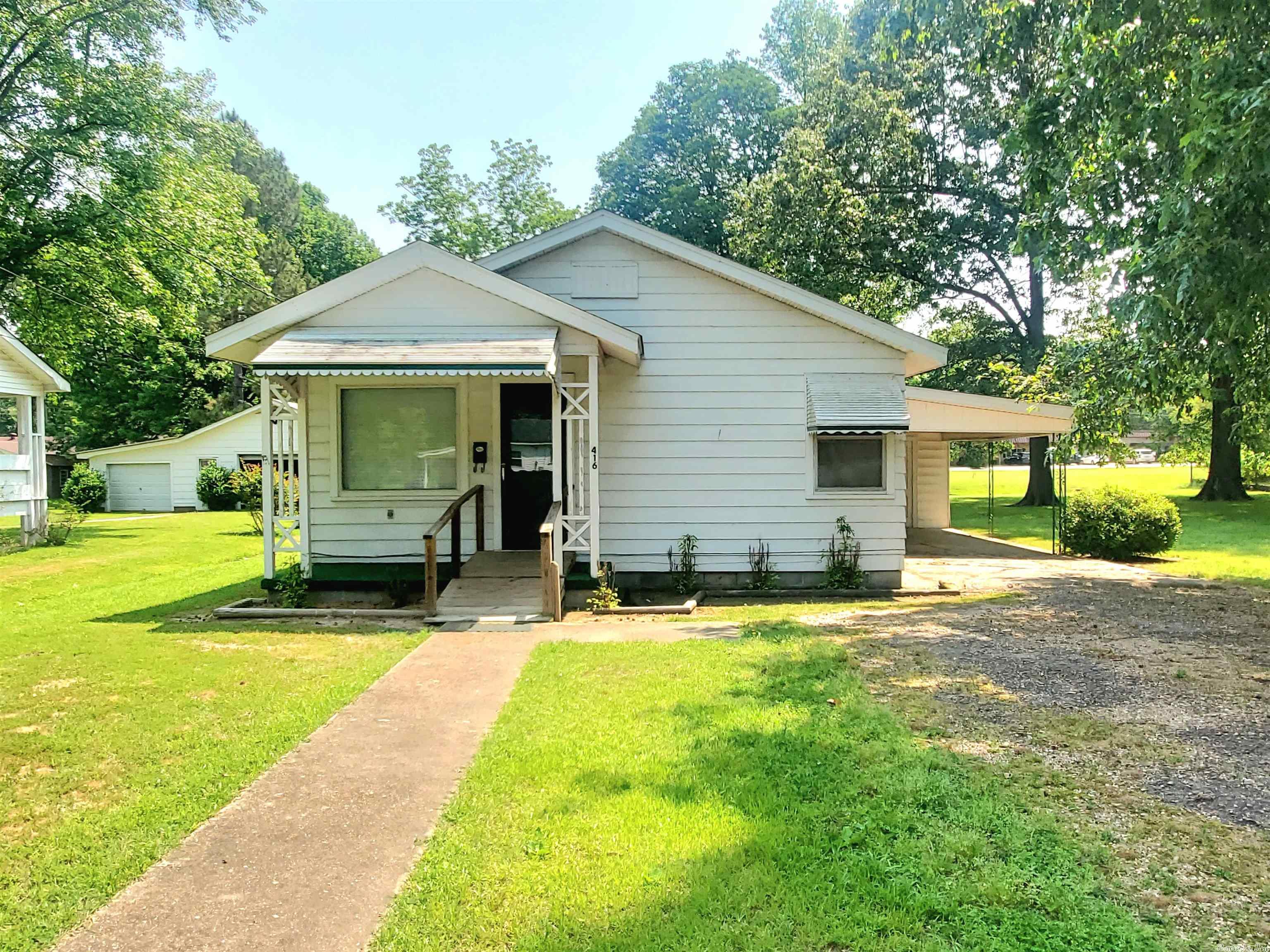 This cozy 2/possibly 3 bedroom, 1 bath home has 1152 sq ft of living space and sits on a large 110'x160' (0.40 acre) lot. The home includes an updated walk-in tiled shower, vinyl plank flooring throughout and a large room off the kitchen that was previously used at a 3rd bedroom but is currently used as a large laundry/utility room. The property also has the original laundry room with backdoor and side door which leads to the attached carport and storage room. This property would be a great starter home for a family or good home for someone looking to downsize in a quiet neighborhood. Call today to schedule an appointment!