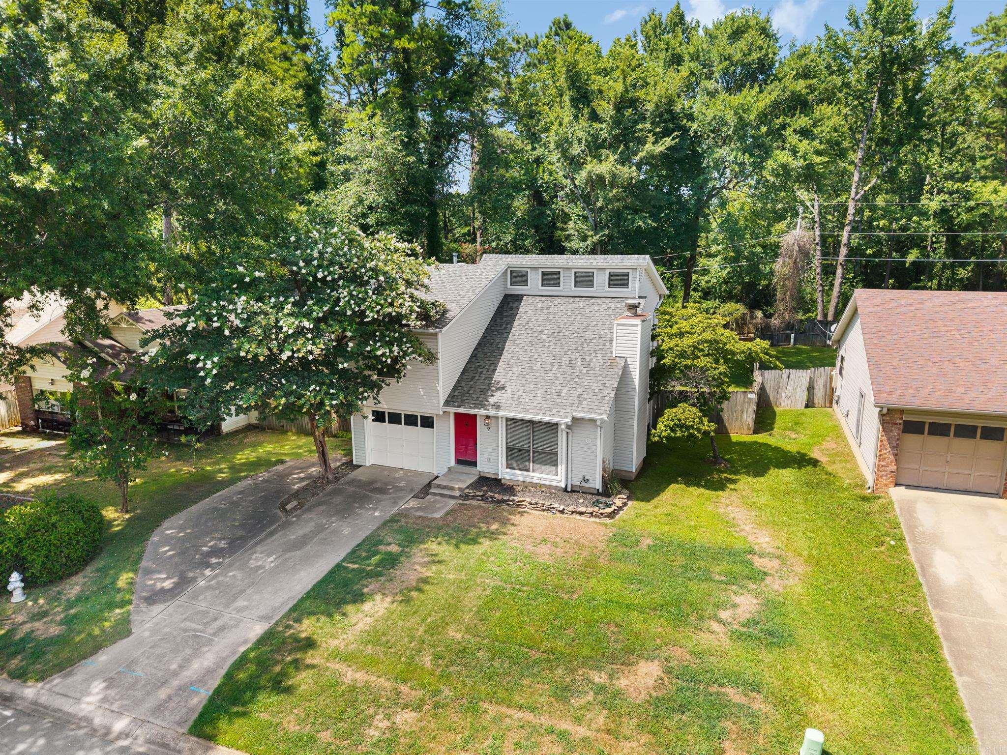 Welcome to 9 Prospect Trail in North Little Rock! This move-in ready home is conveniently located and offers the perfect blend of comfort and character. Recent updates include a newer roof (2022) and new kitchen appliances, giving you added peace of mind from day one. The inviting great room features vaulted ceilings, beautiful hardwood floors, abundant natural light, and a cozy fireplace with a charming shiplap accent. Just off the living area, you'll find the breakfast room and kitchen, creating a functional layout for everyday living and entertaining. Upstairs offers three bedrooms and two bathrooms, including a spacious primary suite with new flooring in the primary bath, granite countertops, and a private deck—the perfect place to enjoy your morning coffee or unwind in the evening. Ceiling fans throughout the home provide added comfort, while the vinyl exterior offers easy maintenance. Outside, you'll appreciate the fully fenced backyard, lush mature trees, a one-car garage with an automatic opener, and an additional parking pad. Conveniently located near shopping, dining, parks, and schools, this move-in ready home is ready to welcome its next owners.