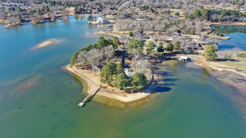 Great Investment! Two homes on a large, level, flat lot with appx 350ft lake frontage! Beautiful one level home on the point with a guest house for extra family. Amazing views, beautiful sunset and sunrise!  Just walk out and you're surrounded by water! Fresh air and sunshine! Lake living at its best! Patio area to enjoy the peace and quiet. Stone fireplace in main home to enjoy in the winter! Lots of storage! Enjoy as your summer home, permanent home or use as nightly rentals. Don't miss out!