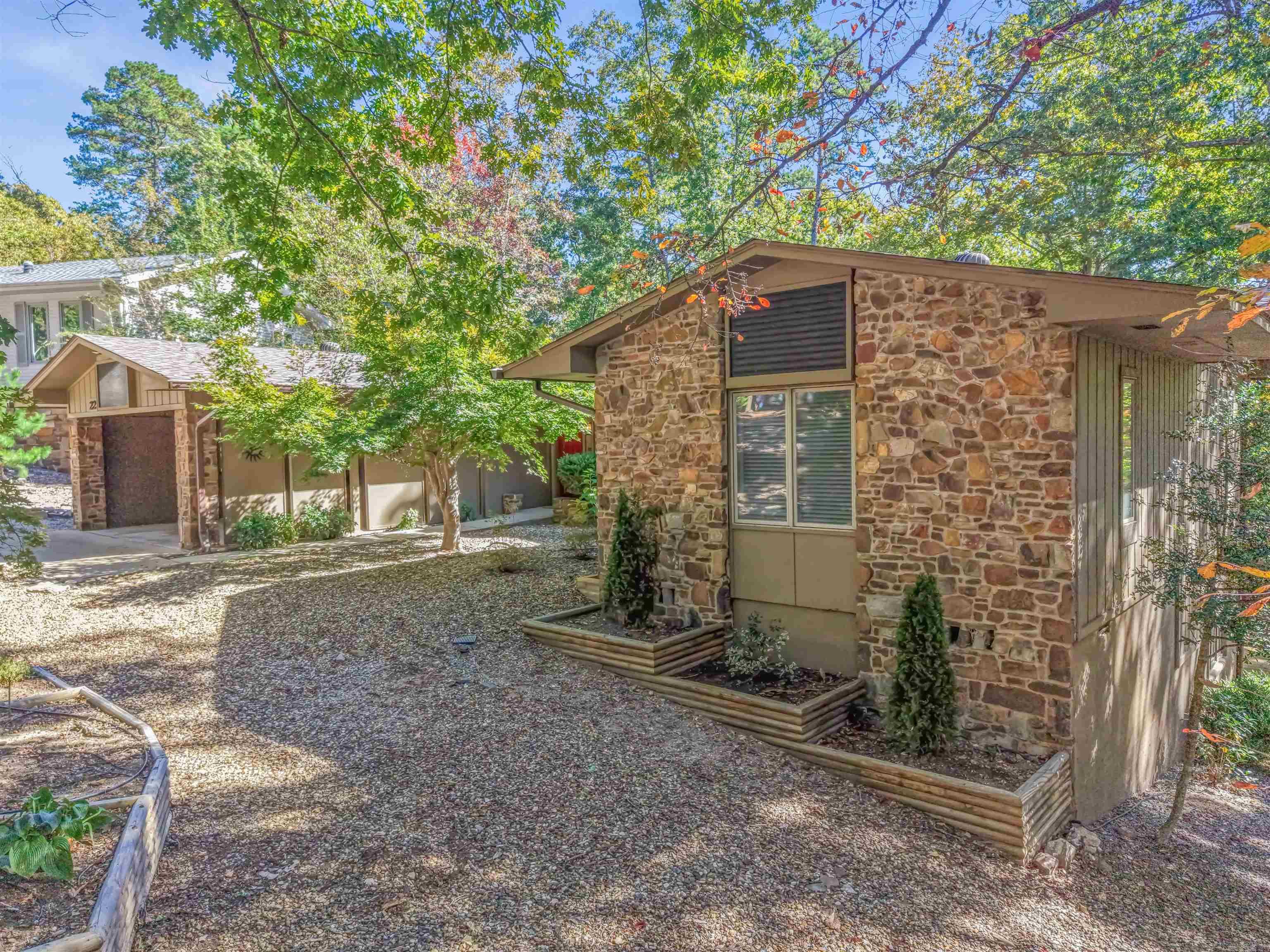 Prepare to be impressed! This meticulously updated 2 bed, 2 bath home is ready for its new owner. Enjoy peace of mind with all major updates complete, including a 2023 Heat Pump, 2023 Water Heater, and a 2024 Roof. The interior shines with a fresh, contemporary look, featuring all new floors, interior doors, and fresh paint throughout. The kitchen is completely updated and connects seamlessly to a bright Sunroom, making it perfect for relaxing or entertaining.  This property is a hobbyist's dream, offering an incredible amount of dedicated space. You'll find a separate heated/cooled workshop and an additional heated/cooled flex room perfect for a home office, storage, or craft area. There is also a detached workshop/she-shed and an extra storage room. Outside, you can enjoy the fresh air on the all-new multi-level deck which overlooks a gently sloping backyard. A dedicated gravel parking area on the side provides convenience for your trailer or golf cart.  Conveniently located near West Gate, this home combines modern updates with fantastic functionality and a prime location. Don't miss the opportunity to make this spectacular property yours! New Member Buy In Fee due at closing.