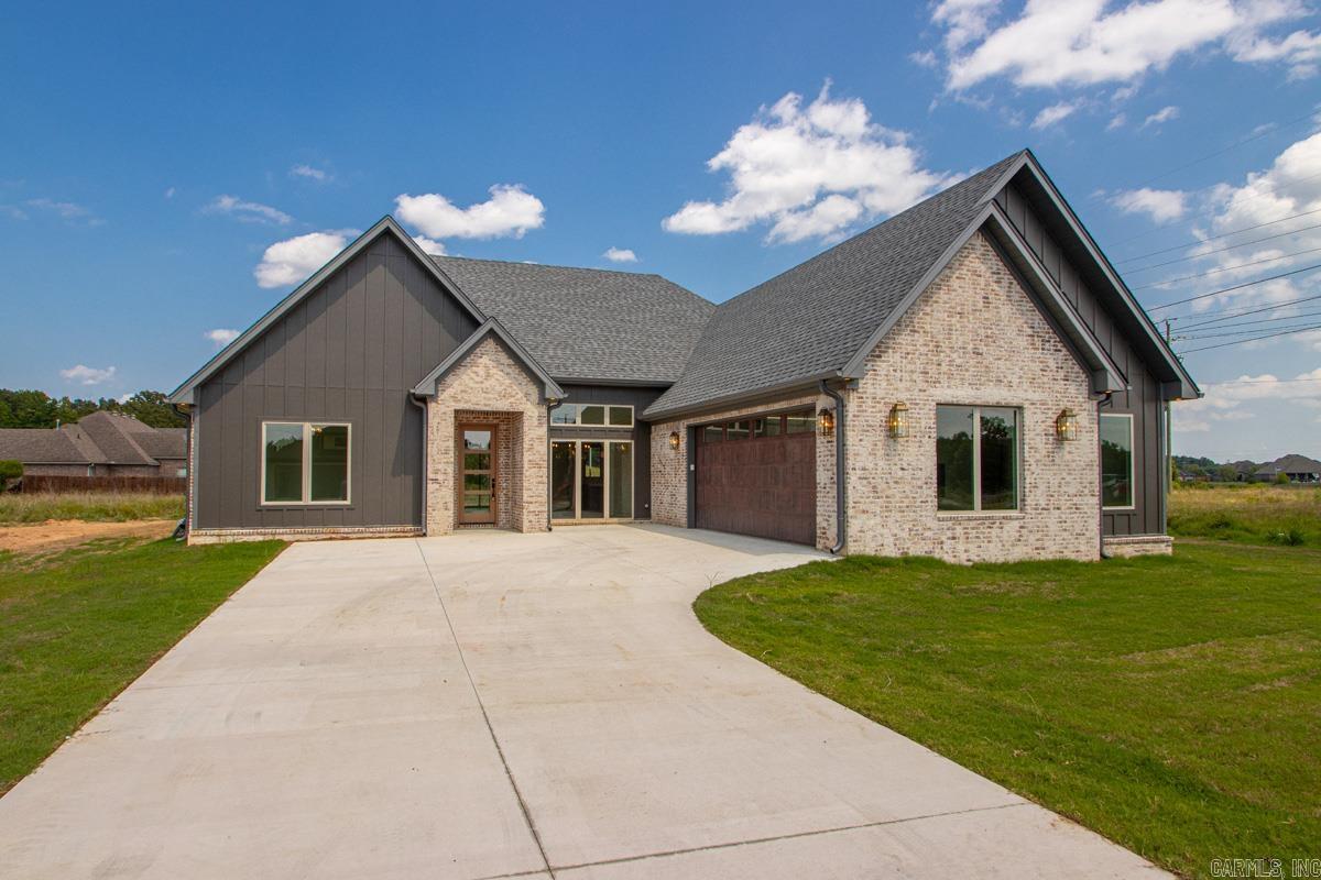 Positioned on Northlake, this brand-new 4-bedroom, 2-bathroom custom lakefront residence perfectly fuses refined architectural character with warm, elevated, organic design. The floor plan is open and split with numerous large windows and sliding back glass doors to promote natural light. Oversized arched openings frame the dining room anchored by custom herringbone white oak hardwood flooring. The heart of the home centers around a showstopping kitchen featuring a 3-inch mitered-edge island, Taj Mahal-inspired quartz, a pairing of white oak and natural cream cabinets, a gas range, wall oven, and an oversized farmhouse sink. The primary suite contains tray ceilings, panoramic lake views, and a handcrafted bathroom containing a wet room complete with a deep soaking tub, custom tile work, and a walk-in shower. Thoughtful craftsmanship continues with vertical shiplap in the laundry room and designer lighting throughout. An energy-efficient tankless hot water heater, architectural shingles, and 2-car garage help complete this new custom build as timeless and functional. Some things are best experienced in person, schedule your showing today!