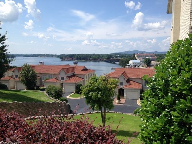If luxurious lake living is what you are wishing for then look no further. Fully furnished with comfortable, classy beach theme, plus spectacular views from windows and balcony! The walk-in master closet has been converted into a third bedroom with bunk beds-perfect for kids or guests. Walk down to your covered boat dock for a day on the lake or enjoy an afternoon poolside. *$10,000 remote boat lift conveys with property as does furniture, agents see Confidential remarks!*