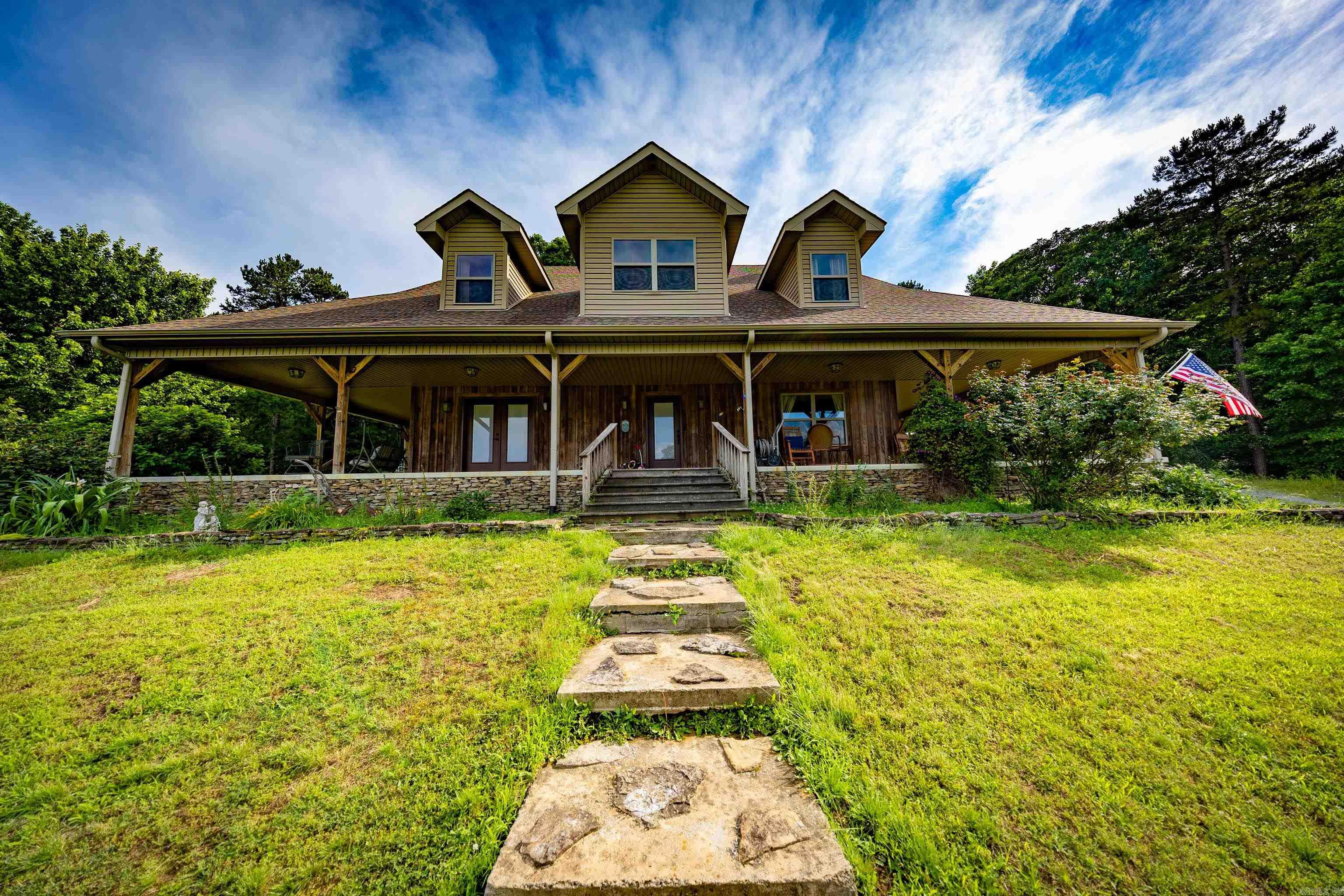 This is a must see with lots of possible and unique extras!  This farm style house has a huge porch wrapping three sides of the house. The back side has a sunroom and screened in porch. The sunroom has a working clawfoot tub and sink, and is climate controlled with a mini split. Upstairs has two almost finished rooms that would add 618 sqft (we did not include it in the total). They are heated/cooled and insulated, but lack dry wall and flooring. It would be easy to add either 2 more bedrooms or office(s) in that space, or possibly another bath or half bath in one, as a bathroom is located below it. ALSO, the 3 acres in front that currently has an old farm house and a mobile home can be purchased as well for an additional price. As can 11 acres of woods to the west of the main house. Did we mention the closet in the primary bath is also a storm shelter/safe room with 6" concrete walls and ceiling? The wall furnace in the living room is gas and meant for backup heat if power goes out. It and the range are the only things that use gas. The common area upstairs has a wall made from reclaimed barn wood from the property. We could go on, but JUST COME SEE IT!