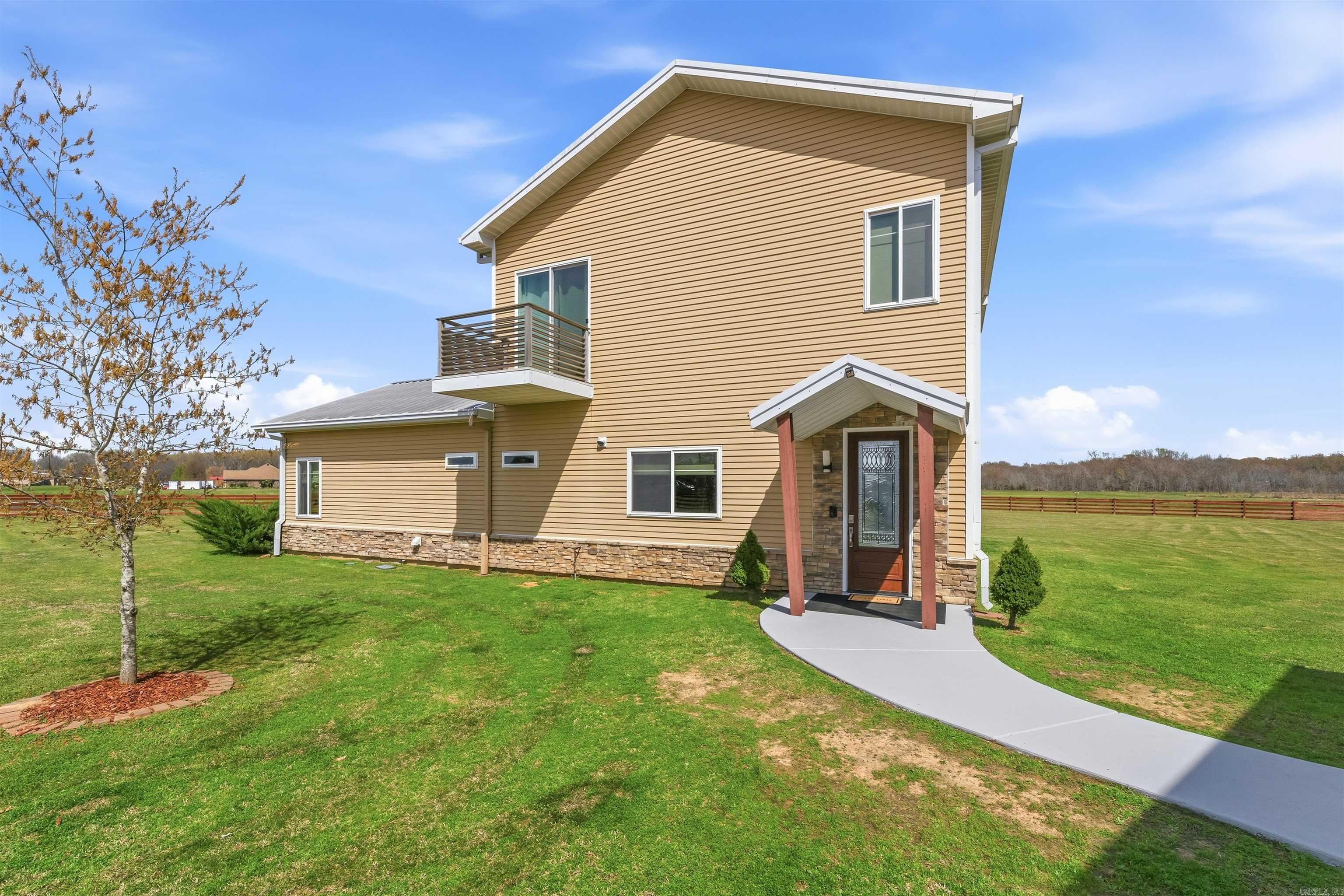 A private Aviation Community with 2 airstrip runways, air indicators and taxiways! This is a beautiful 2,355 square foot home that has been durably built from PolySteel materials. Inside you will love the modern open floor plan, Bamboo flooring downstairs, Cherry wood flooring upstairs, and tile in the wet areas. Enjoy the peaceful view with walls of glass and 2 balconies, one off the living room and one off the upstairs primary suite. Both bathrooms have a luxurious feel and modern features such as raised vanities. Downstairs are 2 guest bedrooms. Upstairs is the perfect retreat in the spacious primary bedroom suite with vaulted ceiling. The sun room at the top of the stair landing leads to a private balcony you will enjoy year round. Now let's talk about the hanger...3,600 square feet with HydroLift door, geothermal heating, plumbed for H20, electric and gas. This is also perfect for the car enthusiast with room for at least 6 cars! At the back of the hanger is your own private gym plus an extra storage area. On the side of the hanger is a covered RV parking area plus a covered area you can park your boat. This property is a must see. You can even fly in for a private tour.