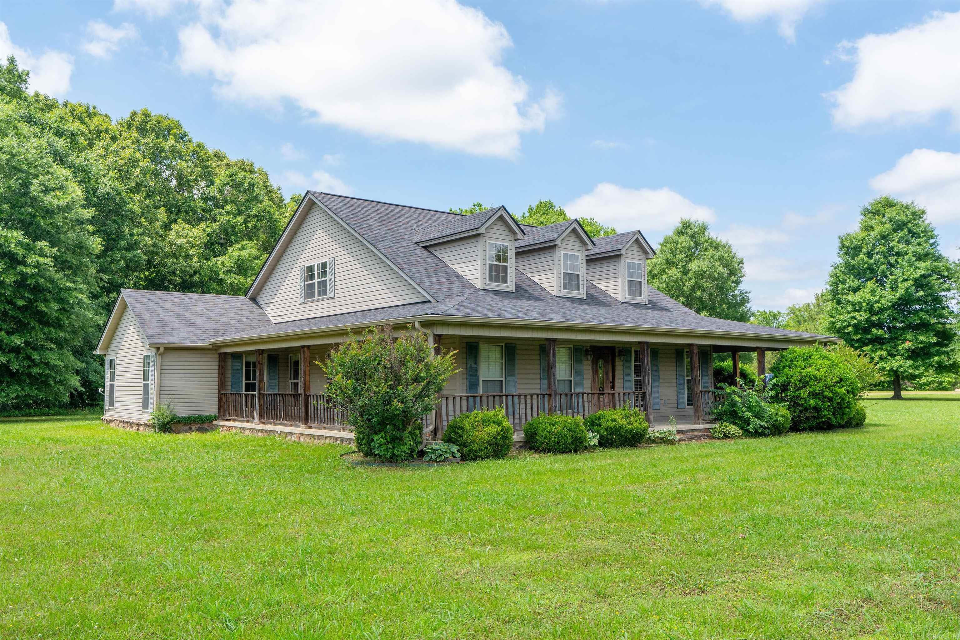 Beautiful home with so much space inside and out. Large eat in kitchen with a huge breakfast bar, large pantry and tons of cabinets including some that are pretty display cabinets. Large living room with a gas log fireplace and lots of space for most any furniture arrangement. Such a great floor plan with no wasted space. Storage closets everywhere, huge laundry room with sink and more cabinets and also an entry from the carport. Large primary bedroom with en suite with a jetted tub, separate shower, double vanity with decorative mirrors, and a nice walk in closet with built in shelving. The kids bedrooms are separated by a full bathroom with a double vanity.  Lots of windows, large wrap around porch and huge attached covered carport with enclosed storage. The roof is new is 2025 and HVAC in 2023. There is an electric generator plug, and the house is on First Electric and also Connect2First Internet that the seller says is amazing. The property is a mixture of open pasture/fields and woods plus a creek that runs through this property. The minerals are not owned by the seller so they do not convey. Audio and Video Surveillance in Use! 24 Hour notice for Showing Appointments please.