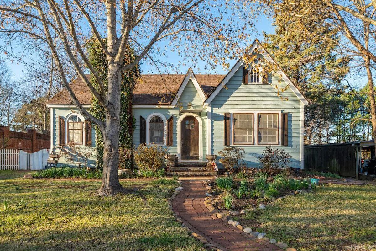 Discover a "most unique paradise" in the heart of Clarksville. This enchanting 2-bedroom, 1-bath cottage on E Poplar St blends historic character with modern luxury. The interior will surpass your imagination with original hardwood flooring, elegant arched windows, and spacious rooms filled with built-ins. Step outside to a private, fenced backyard featuring a tranquil pool with a sprinkler meter which lowers your water bill drastically—the ultimate storybook setting for relaxation. With a Crawford ceiling in the living room, crown molding in the bedrooms.  This home offers peace of mind along with its undeniable charm. Whether you’re looking for a personal sanctuary or a high-performing investment, this property is truly a one-of-a-kind find! This house is currently a successful Airbnb for interested investors. There is currently nothing else like this on the market so don't delay in making your appointment to see this beautiful home.