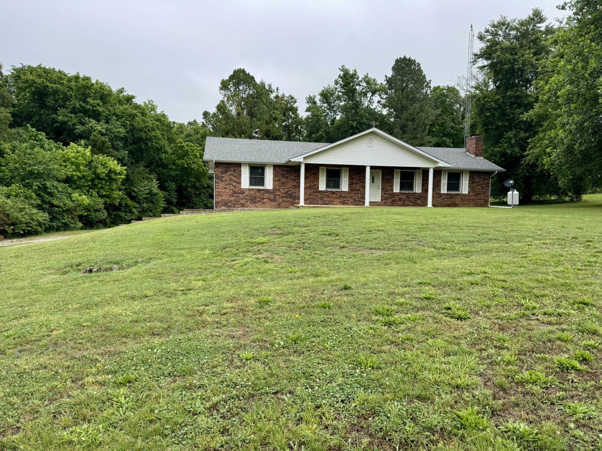 This charming 3 bedroom 2 1/2 bathroom brick home resides on 2+ acres in the town of Wiseman, Arkansas, blending town convenience with rural appeal in North Central Arkansas. Step inside to 1,680 sq ft of main-level living space, where all bedrooms and bathrooms are conveniently located on one floor. A 1,008 sq ft unfinished basement offers endless potential for your custom finishes. The home is complemented by beautiful hardwood flooring installed just a year ago and a cozy fireplace with gas logs that can easily convert back to wood. In addition, there’s a newer well pump, central heat and air, fiber optic high-speed internet from NEXT, and an architectural shingle roof less than 10 years old. Outside, there is a big front and back yard—perfect for gardening, play, or relaxation—plus a 2-car garage for added convenience. This move-in ready home with acreage is priced to sell at only $149,900, ideal for families seeking affordable Arkansas real estate with room to grow.