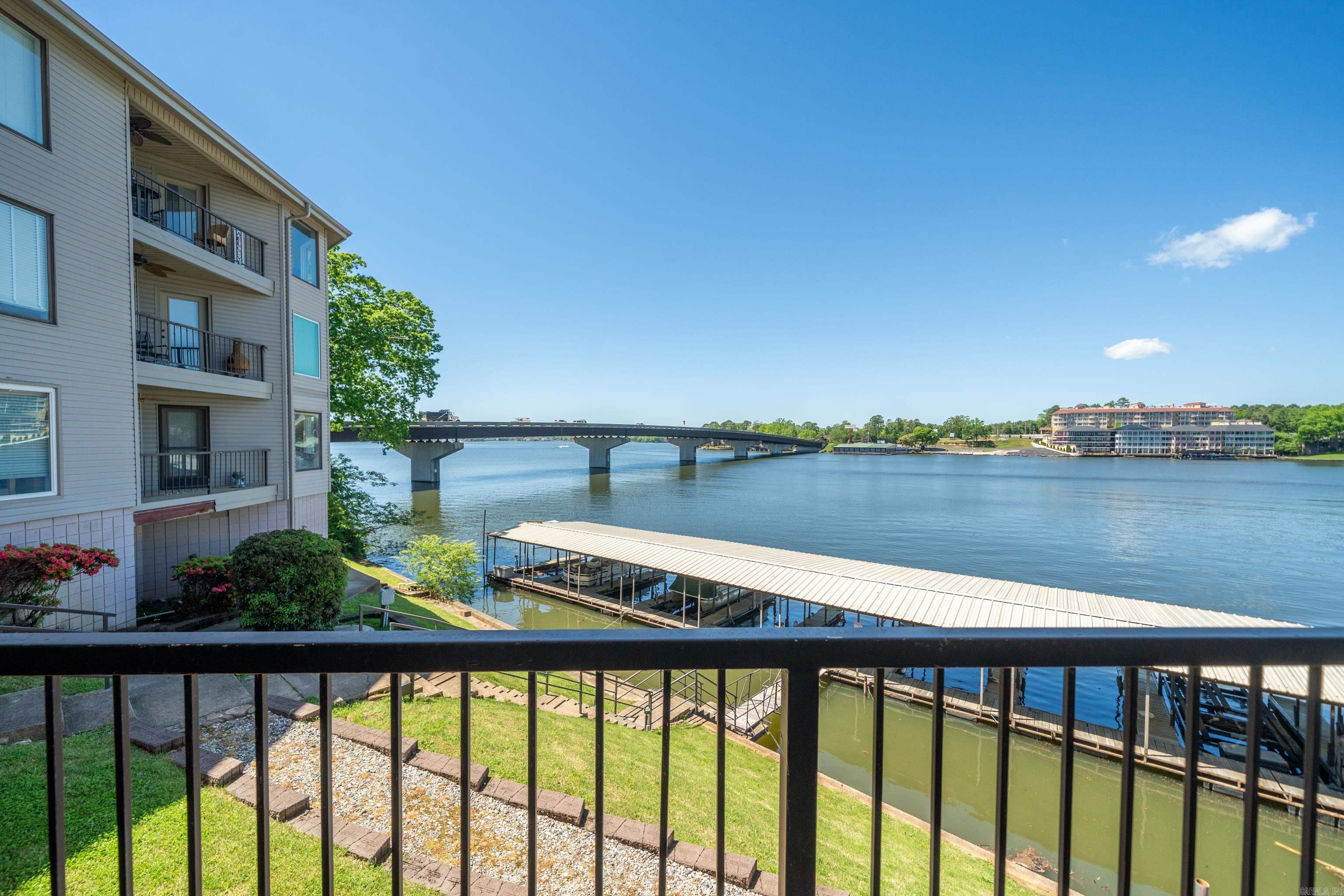 The best priced Lake front Condo on Lake Hamilton! Welcome to lakefront living at its finest! This beautifully updated 2-bedroom, 2-bathroom condo offers 1,648 sq. ft. of comfortable living space with stunning waterfront views. Move right into this gem comes fully furnished, so all you need to bring is your sense of adventure and maybe a fishing pole. Speaking of water fun, the covered boat dock with boat lift is ready for your vessel, making every weekend feel like a vacation. The location is ideal for short-term rentals, offering incredible income potential. Nestled in a prime Hot Springs location, you're minutes from Oaklawn Casino for evening entertainment and convenient shopping at nearby grocery stores. Whether you're seeking a personal lakeside retreat, a profitable rental property, or both, this condo delivers on every front. Schedule your private showing today and discover why lake life is the best life!