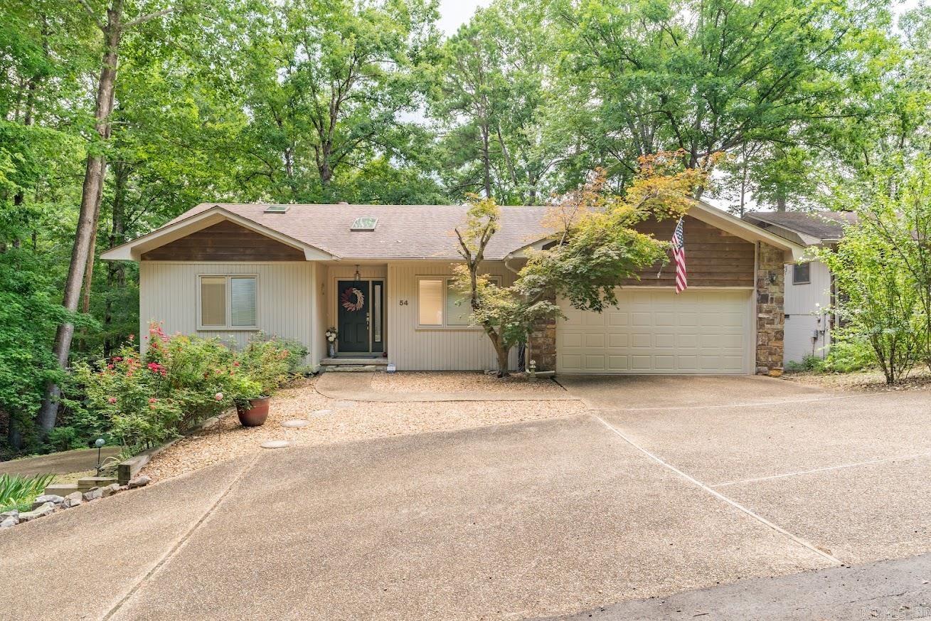 Rare find in Hot Springs Village! This golf-front property offers outstanding flexibility as a primary residence, vacation home, or income-producing investment. Located less than three minutes from the West Gate, DeSoto Golf Club, pool, pickleball, shopping, and restaurants, it provides easy access to many of the Village's top amenities. Designed to live like two homes in one, this single-family residence features separate entrances, driveways, and garages—ideal for multi-generational living, guests, or rental income. Live on one level and rent the other, or maximize its short-term rental potential. Both levels feature durable hard-surface flooring, while the upper level offers a split-bedroom layout. A golf cart garage and paved path provide access to the course and walking and biking trails. Recent updates include refreshed decks and stairs, interior paint, added attic insulation, whole-house water filtration, HVAC UV air purification, a water heater timer, and new upstairs washer and dryer. The furnished lower level is turnkey and rental-ready. Termite and roof inspection reports are available. Move-in ready with exceptional versatility and income potential.