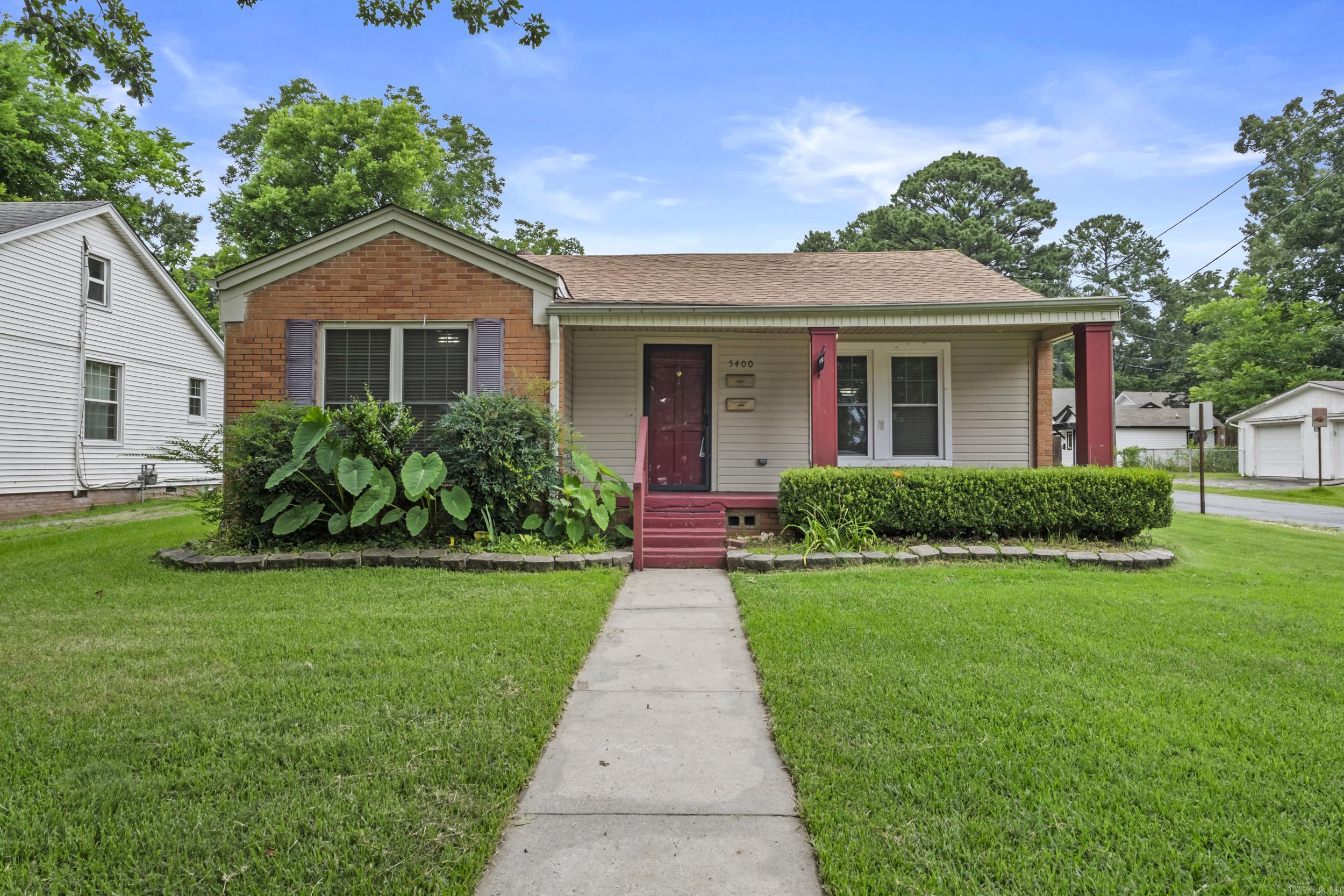 Welcome to this spacious 5-bedroom, 2.5-bath home situated on a corner lot in the sought-after Hillcrest neighborhood and located within a highly desirable school district. Full of character and functionality, the home features original hardwood floors throughout the main living areas. The eat-in kitchen offers granite countertops, a breakfast bar, gas range, abundant cabinet space, and a separate dining room, making it ideal for both everyday living and entertaining. The refrigerator conveys with the property. The private primary suite provides a relaxing retreat with a jetted tub, walk-in shower, and a spacious walk-in closet with custom built-ins. Storage is plentiful throughout the home, including extensive attic storage. An attached workshop offers the perfect space for projects or additional storage. Outside, enjoy the fully fenced backyard with decorative iron fencing, a Morgan storage building, and additional outdoor storage space. Conveniently located within walking distance of parks and the zoo and minutes from the university, hospitals, shopping, dining, and other amenities, this home combines space, comfort, and an exceptional location. A must-see to fully appreciate!!