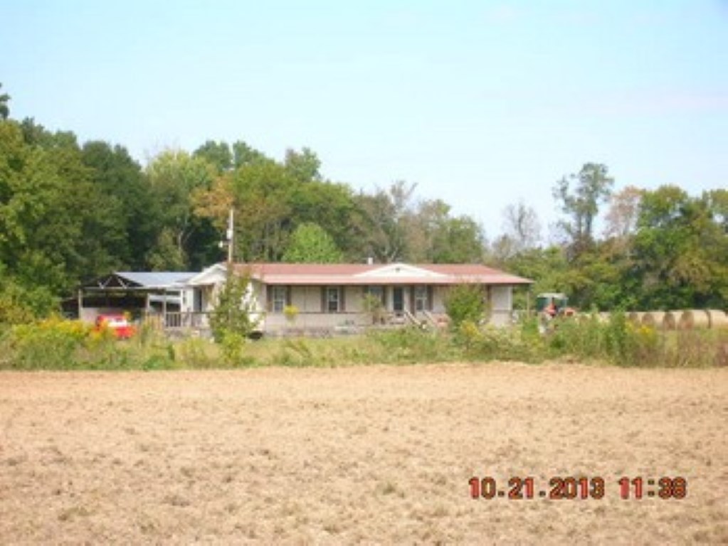 Prime acreage with approx. 700-1000 ft. on the Ouachita River. This working cattle farm includes cross fencing, working pens and city water. Double wide mobile  home located on property for your worker, plus pole barn. Just minutes from I-30.