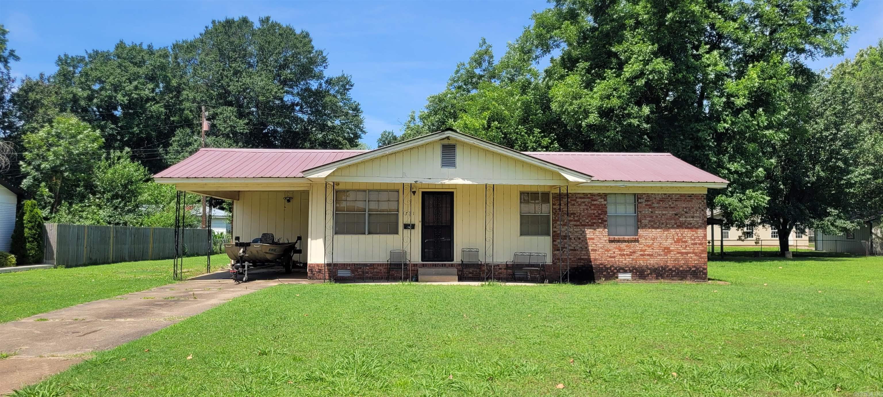 Three bedroom one bath house in quiet, established neighborhood being sold AS-IS with the exception of the removal of one set of bedroom furniture and a few personal items. The refrigerator, washer and dryer, and all other furniture will stay. The house has approximately 1117sqft living space, a cozy front porch, and metal roof. There is even a small shed and additional covered storage in the back yard. Great starter home or remodel opportunity for the DIY-er! A few easy upgrades like flooring and paint would enhance the interior of this super cute home. If purchased as a primary residence, the Homestead Tax Credit covers all of the property taxes.