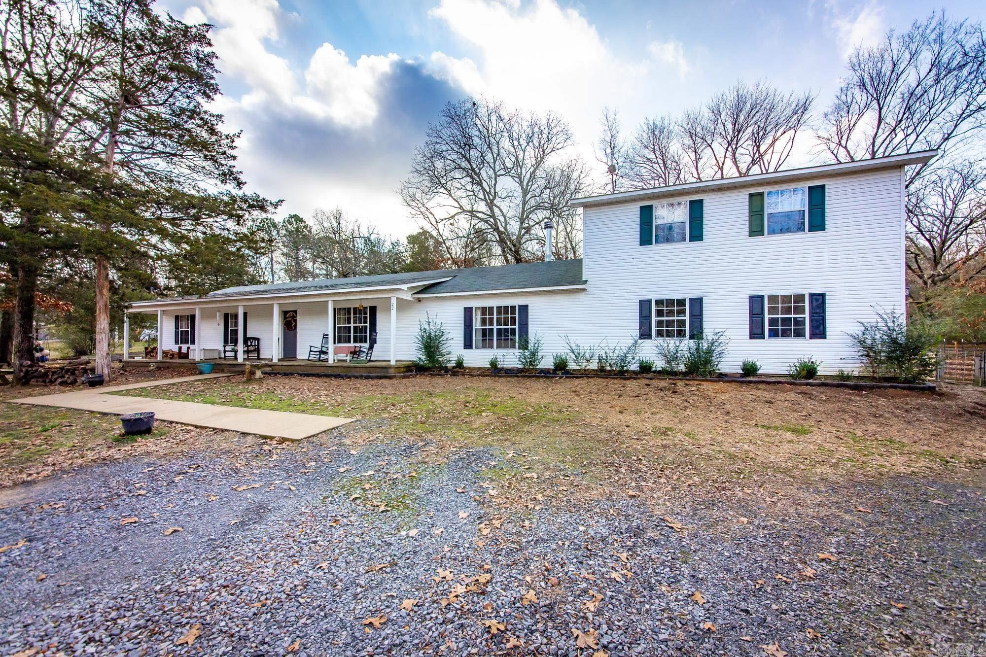 Charming Hobby/Mini Farm Oasis between Greenbrier & Conway! Set on a picturesque parcel, this property is brimming with features that cater to both comfort & country living. The primary home sits on a spacious, level lot adorned with mature trees & offers wonderful outdoor amenities. Enjoy your morning coffee in the serene greenhouse or pick fresh herbs just steps from your kitchen in the dedicated herb garden. Let your chickens roam happily in the well-maintained coop, & fenced area, while family & friends gather in the expansive, open-concept living room and kitchen—ideal for making memories together. The main level features three comfortable bedrooms & two full baths, providing family-friendly functionality and privacy. Unwind on the welcoming front porch, or host summer barbecues & cozy gatherings on the back patio that overlooks the peaceful backyard. You'll also love the versatile shop/workspace—perfect for DIY projects & hobbies—as well as a covered carport to accommodate your RV, boat, or additional vehicles.  Additional 8 acres across the street available. Nature enthusiasts will rejoice in the meandering creek. Includes lot & barn across the street.