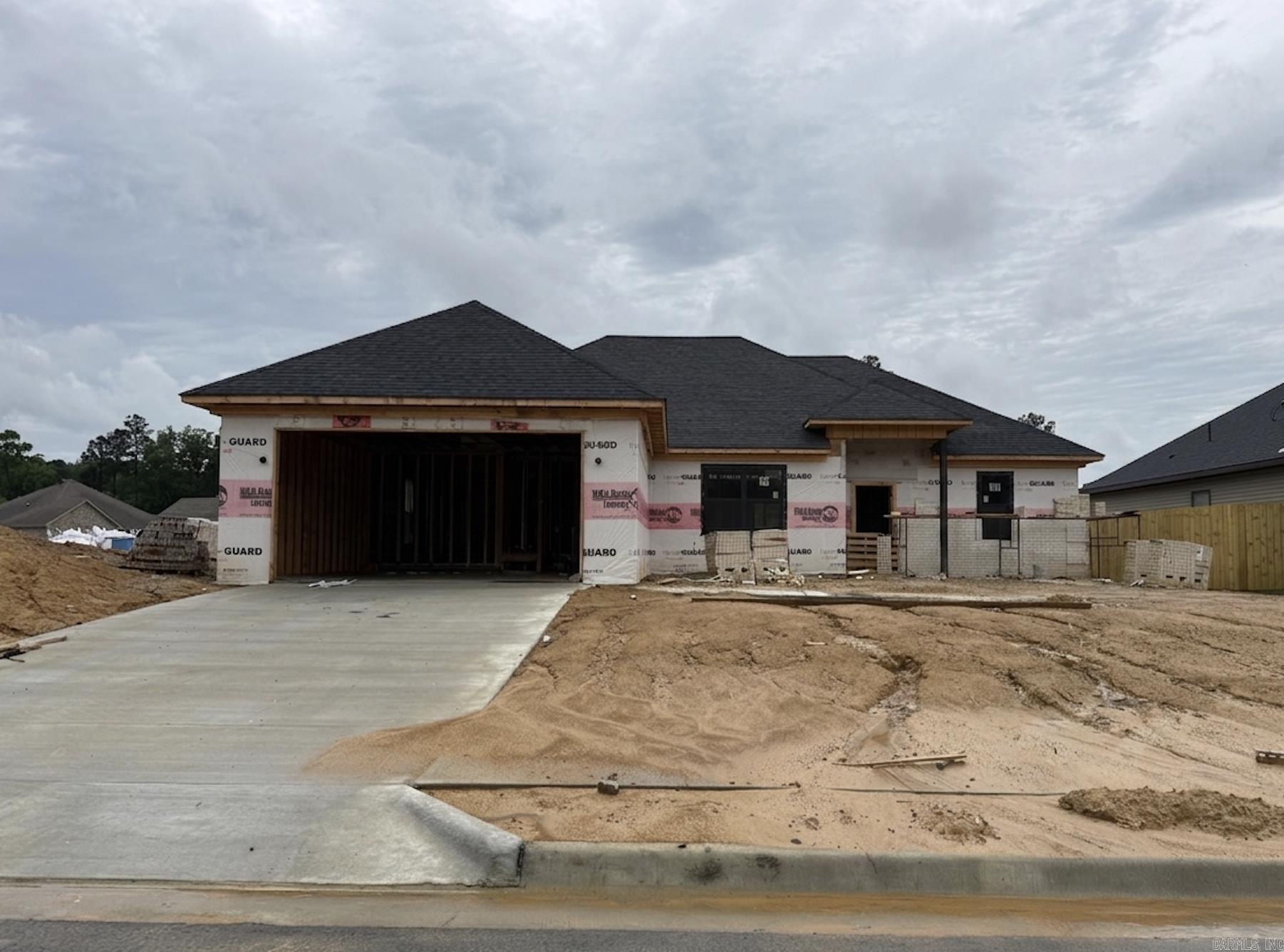**$10K buyer credit—use it your way!** Welcome to Springtree Village Phase 5, where quality and comfort meet in a peaceful, country setting just minutes from town. Enjoy thoughtful details like tray ceilings, canned lighting, granite countertops, ceiling fans with light kits, and architectural shingles. The garage comes finished with sheetrock, paint, and a garage door opener for convenience. The home offers a quiet setting with easy access to town. Each home includes a 1-year Builder Warranty for added peace of mind. Lot dimensions and acreage are estimated from the plat map; buyers should verify and calculate lot size using their own measurements. Taxes are TBD. Don’t miss the opportunity to own this beautiful new build! Interior images are from one of the completed homes. Some images have been virtually staged.