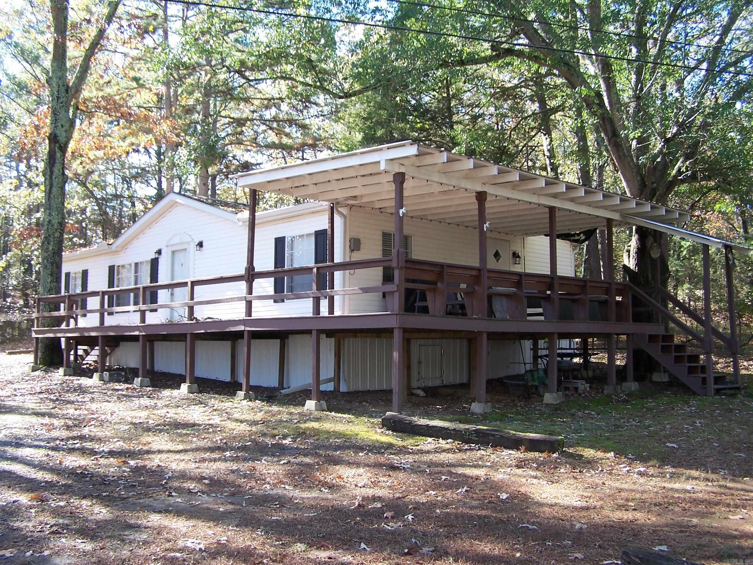 Great location near marina with covered community boat dock...1.19 acres...Fairfield Bay address but no POA dues...move in condition with furniture included....covered deck with view of Greers Ferry lake and Sugarloaf Mountain....convenience of Fairfield Bay amenities within minutes.... can be purchased with neighboring property 137 and 145 Jay Tee....MLS # 26008829...