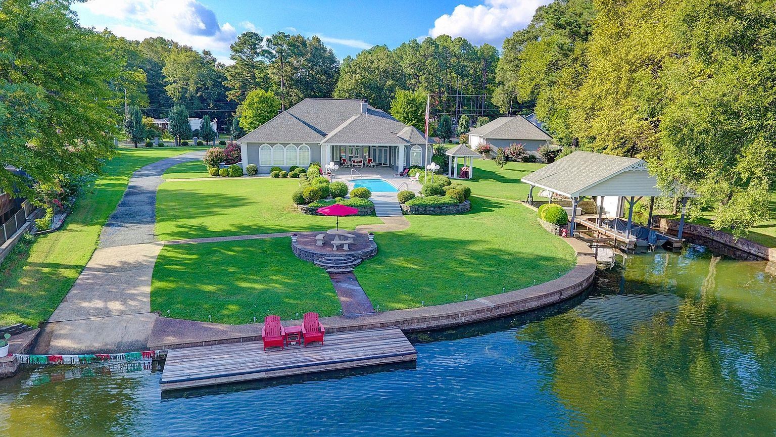 Luxury Lakefront Haven! 3240 sq ft of fine craftsmanship. En suite MBR w/sitting area and French Doors to pristine pool and lake. 2 En suite guest rooms plus a large office which could be 4th bedroom. Cook on your induction stovetop range while enjoying breathtaking views of Lake Hamilton. All appliances stainless.  Massive 2500 sq ft(H&C) workshop for your toys. Extras: 2 covered boat slips w/hoists, private boat launch, swim dock, pool, whole home generator, sprinkler system, gated entry. Agent remarks.