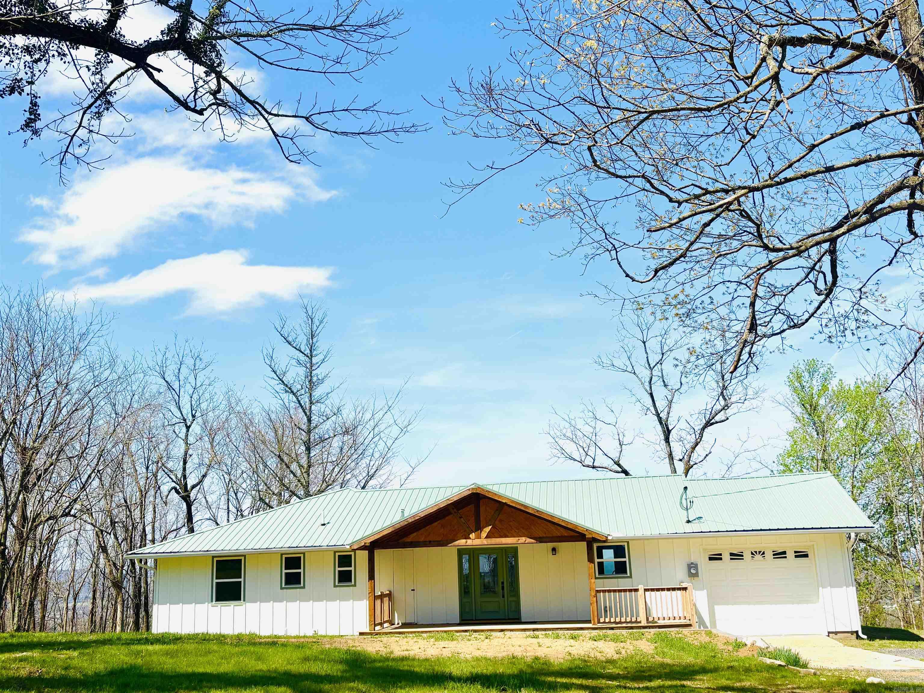 From the moment you pass the South Mountain Scenic Overlook up to this property, the stunning views of the Boston Mountains, the highest and most rugged part of the Ozarks, are like no other! Enjoy spectacular and breathtaking sunsets from the privacy of the new back deck featuring views stretching to the horizon painting a panoramic postcard of sheer bluffs, Oak, Pine, Hickory forests, rivers and creeks that changes with every season! This beautiful 3-bedroom home offers almost 1500 sq ft and has been completely renovated to brand new! Fresh new paint, beautiful hardwood flooring, completely updated bathrooms including a large walk-in tile shower with glass doors, Maple vanity with dual sinks, and all new kitchen with new stainless appliances, Maple cabinets, and quartz countertops. The bedrooms have spacious closets with built-in shelving, the primary having dual closets, a build-in hall cabinet with drawers, maple cabinetry in the laundry and main bath, a large hall closet that could also be used as a pantry, plus additional cabinets and shelving in the garage. New insulated windows and doors, new covered front porch and front door, exterior paint, guttering, and new sidewalks.