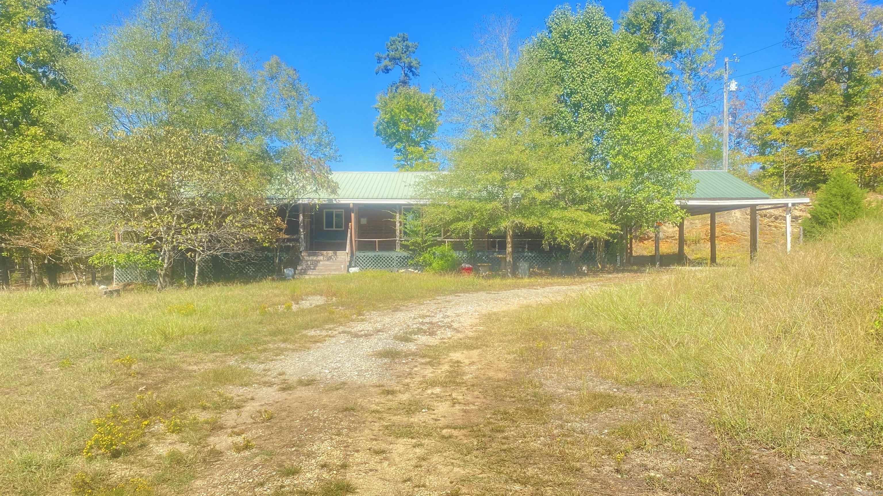 Great hunting and lots of privacy! This home sits on 27.5 acres with a wet weather creek, lots of trees and nature opportunities ! Hunting lease on west and north sides can potentially expand your hunting area! Log exterior with a covered front porch across the front of the home! Short trip down to the river and Lake Norrell boat ramp is just minutes away! Rustic interior with nice kitchen, bedroom and bath arrangements! This home has also been made handicap accessible! See Agent Remarks.