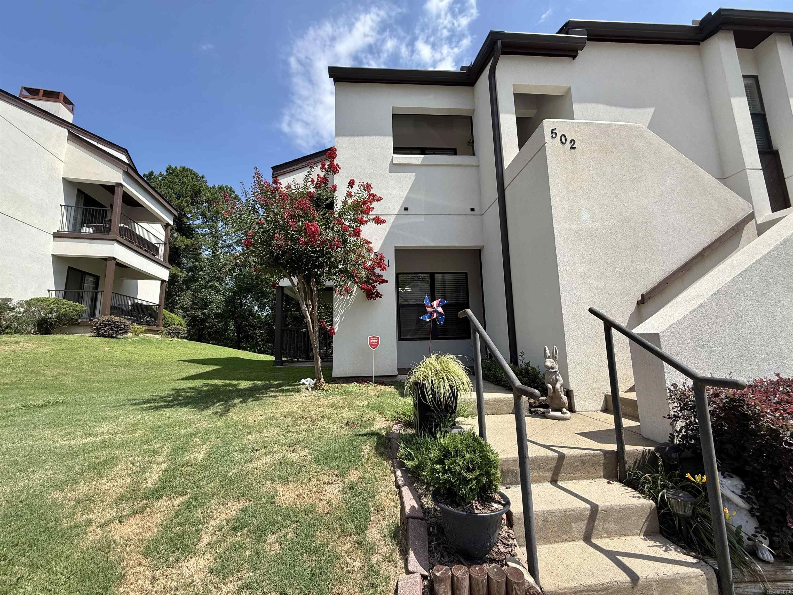 LOCATION!!  LOCATION!! LOCATION!!  This amazing move in ready condo is waiting for you to make it all yours!!!  Highly sought after well maintained downstairs unit sits close to shopping of all kinds,mid-town, downtown and West Little Rock. Ground level unit features 2 spacious bedrooms and 2 full bathrooms with a separate dining area and office/bonus area as well.  The living room offers a warm and inviting ambiance, highlighted by a wood-burning fireplace offering a cozy focal point.  Enjoy your large kitchen with stainless steel appliances and pantry.  Step out to the back patio for a breath of fresh air.  Enjoy your morning coffee on the covered back patio or glass of wine in the evening, or simply enjoy the on-site community pool. Fees cover the roof, exterior, grounds maintenance, water, trash/recycle and chimney cleaning each year.  This unit has new roof 2025 and new carpet 2023 and new stove (never used) 2026.  Home also features a smart thermostat that can be controlled by your smart phone from anywhere.  Call and schedule your showing today and let's make this amazing home all yours!!!