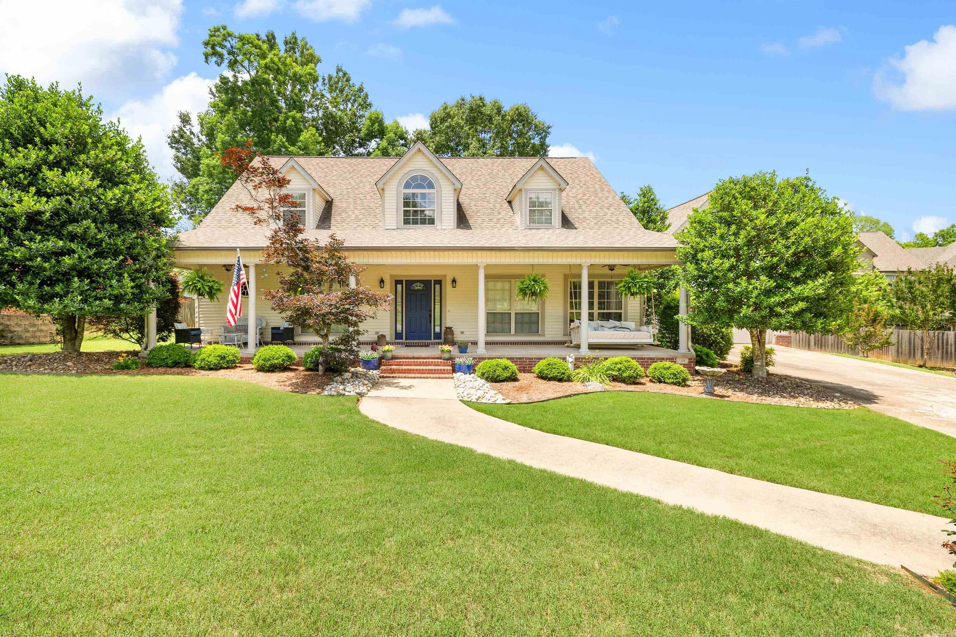 Some houses are simply houses — this one is truly a home. Filled with charm and comfort, every room invites you to settle in and stay awhile. A welcoming front porch sets the tone, leading into a thoughtfully designed interior with plenty of space to enjoy.  The spacious kitchen is a cook’s dream, featuring a gas stove, walk-in pantry, and open flow into the warm and inviting living room. The oversized primary suite offers generous wall closets, a large walk-in closet in the bathroom, a jetted tub, and a step-in shower for a true retreat experience.  Downstairs also includes a private guest bedroom with its own full bath, a dedicated office, dining room, craft closet, and convenient half bath. Upstairs, you’ll find two large guest bedrooms along with a full bath and additional half bath.  The garage is one of the largest in the neighborhood — approximately 20 feet wide by 38 feet deep — with room to comfortably park up to four large vehicles or create the perfect hobby or workshop space in the rear portion.  Outside, the beautifully manicured front and back yards provide exceptional curb appeal, while the expansive back patio is ideal for entertaining and extending gatherings outdo