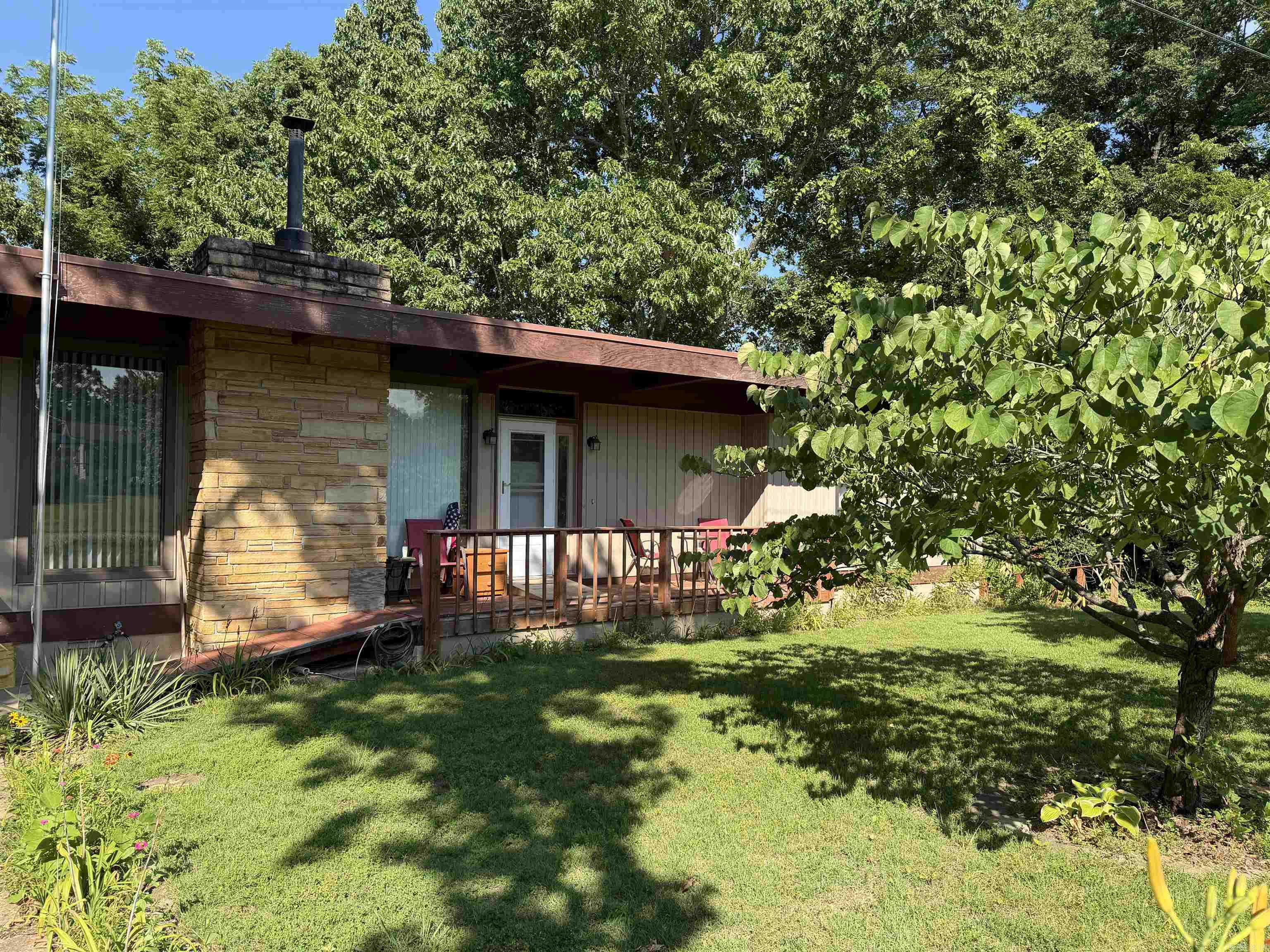 Looking for space, privacy, and a spot to call your own? This 2 bedroom, 2.5 bath home in Bull Shoals sits right up against Corps of Engineersproperty, giving you a private backyard buffer that can't be built on — and you're just minutes from Lake Bull Shoals, one of the best catfish andbass fisheries in the Ozarks. An additional wooded lot is included in the sale — extra room to roam, room for a garden, storage, or just moreprivacy between you and the world. Walkout basement with a pool table and dedicated workshop space — perfect for hobbies, projects, or justkicking back Cozy wood-burning fireplace for those cool Ozark evenings. Stainless steel appliances in the kitchen. Washer/dryer comboincluded. Two tankless water heaters, so you'll never run out of hot water. Thoughtfully designed for wheelchair accessibility throughout most ofthe home. The rear deck is not yet built — a blank slate ready for you to design and build your own outdoor space exactly how you want it.