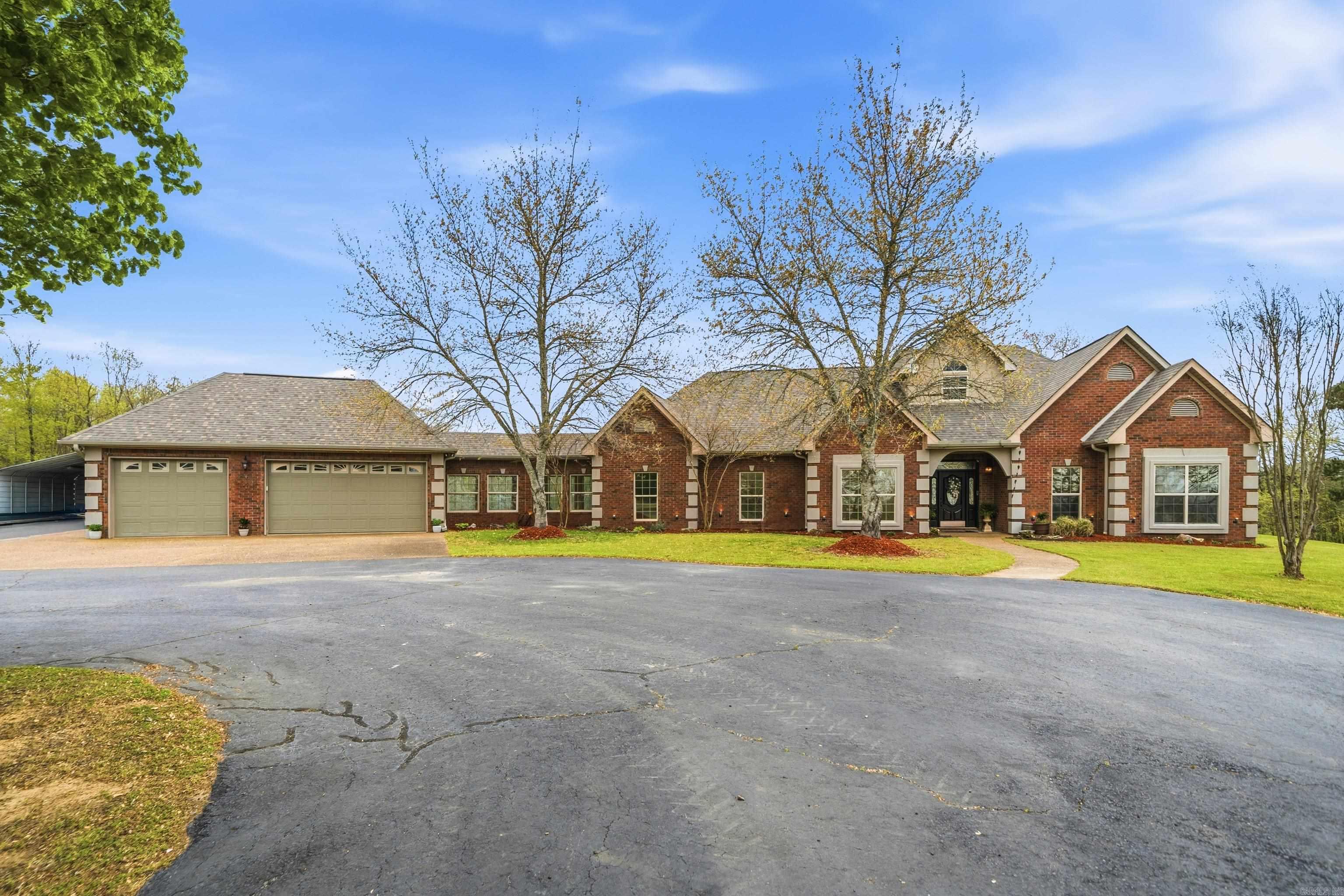 AN EXCEPTIONAL CUSTOM DESIGN & BUILD by a master craftsman builder (all 2x6 exterior walls) for his own daughter, 4 BEDROOMS, 3 FULL BATHS + 1/2 bath on a very PRIVATE 5.86 AC. hilltop with stunning views in all directions! This one is loaded!! LOCATION is perfect for commuting to Benton/Bryant/HS areas...The CUSTOM MILLWORK is magazine award worthy! Spacious great room w/gas fireplace for enjoyable gatherings. Plenty of gorgeous storage & built-in's everywhere you look..and don't miss the kitchen cabinetry, granite counter, SS appliances, built in ovens, brkf bar & lg walk-in pantry. Sequestered PRIMARY SUITE w/private exit to covered outdoor living plus a spa like oasis ensuite complete with garden tub & walk in STEAM SHOWER! 2nd living area (multi use), glassed in breezeway connects to 3 car garage. 22x30 METAL BUILDING w/attached lean-to shed large enough for a big boat! Lg covered back porch plus stone benches & firepit. Addt'l 25x30 concrete slab..ready for whatever you want to build!  FULL HOUSE GENERATOR!  50 AMP  for motorhome.  SO MANY GREAT FEATURES!!  COME SEE THIS ONE TODAY!