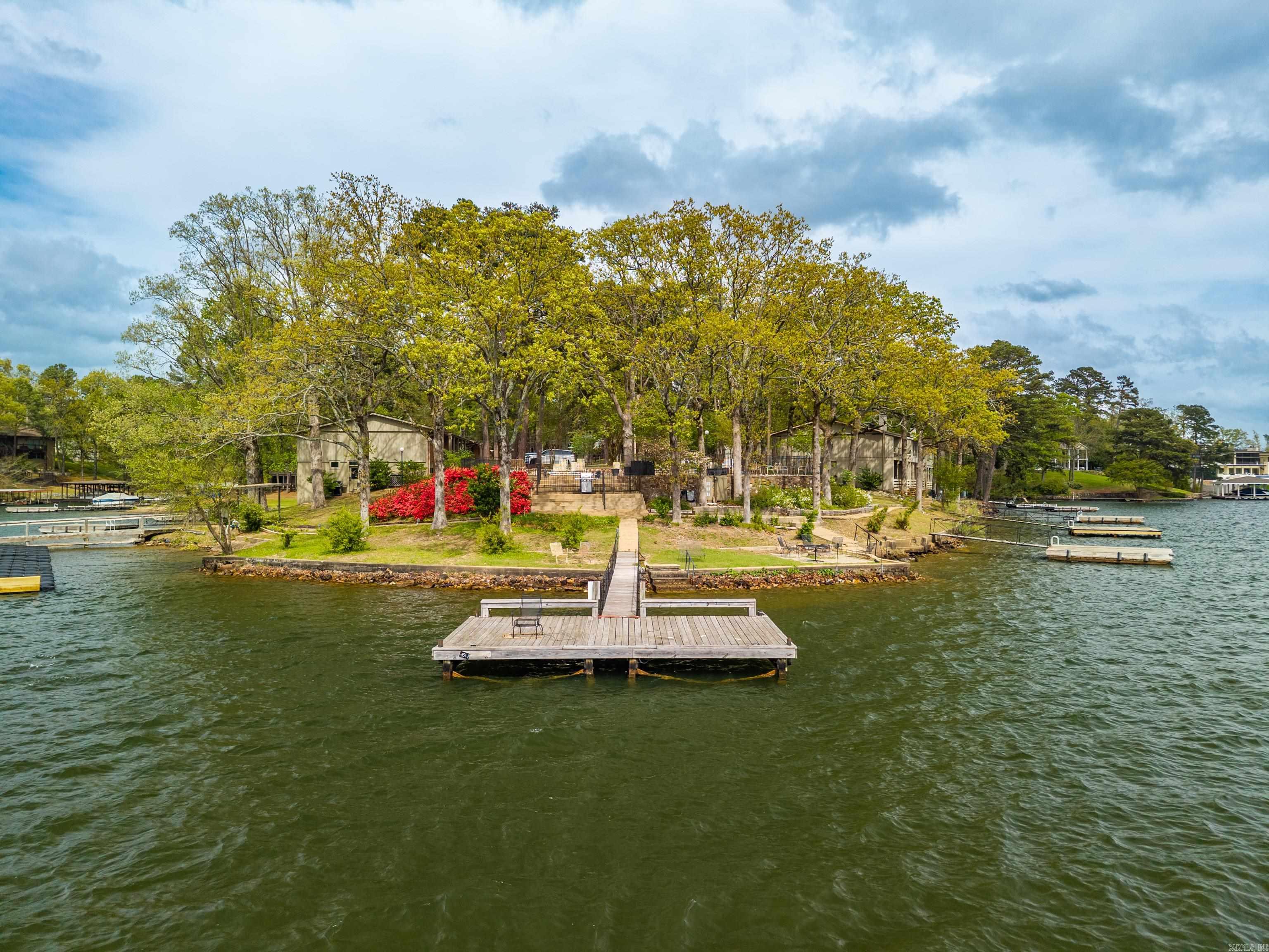 Looking for a full-time vacation? Welcome to Baywood Colony—your lakeside retreat on beautiful Lake Hamilton! This fully furnished 2-bedroom, 2.5 bath condo offers 1,188 sq ft of stylish comfort and peaceful views from your private patio. Whether you’re sipping morning coffee or winding down with a sunset glass of wine, the lake is always your backdrop. Move-in ready! This gated community offers resort-style living with a sparkling pool, lots of common areas for evening strolls, and a boat dock to soak up the summer fun. Perfectly located not far from shopping, dining, and medical services, you’ll love the convenience as much as the relaxation. Whether you're searching for a full-time residence, weekend escape, or investment opportunity—this one checks all the boxes. Don't miss your chance to live the lake life—schedule your private showing today!