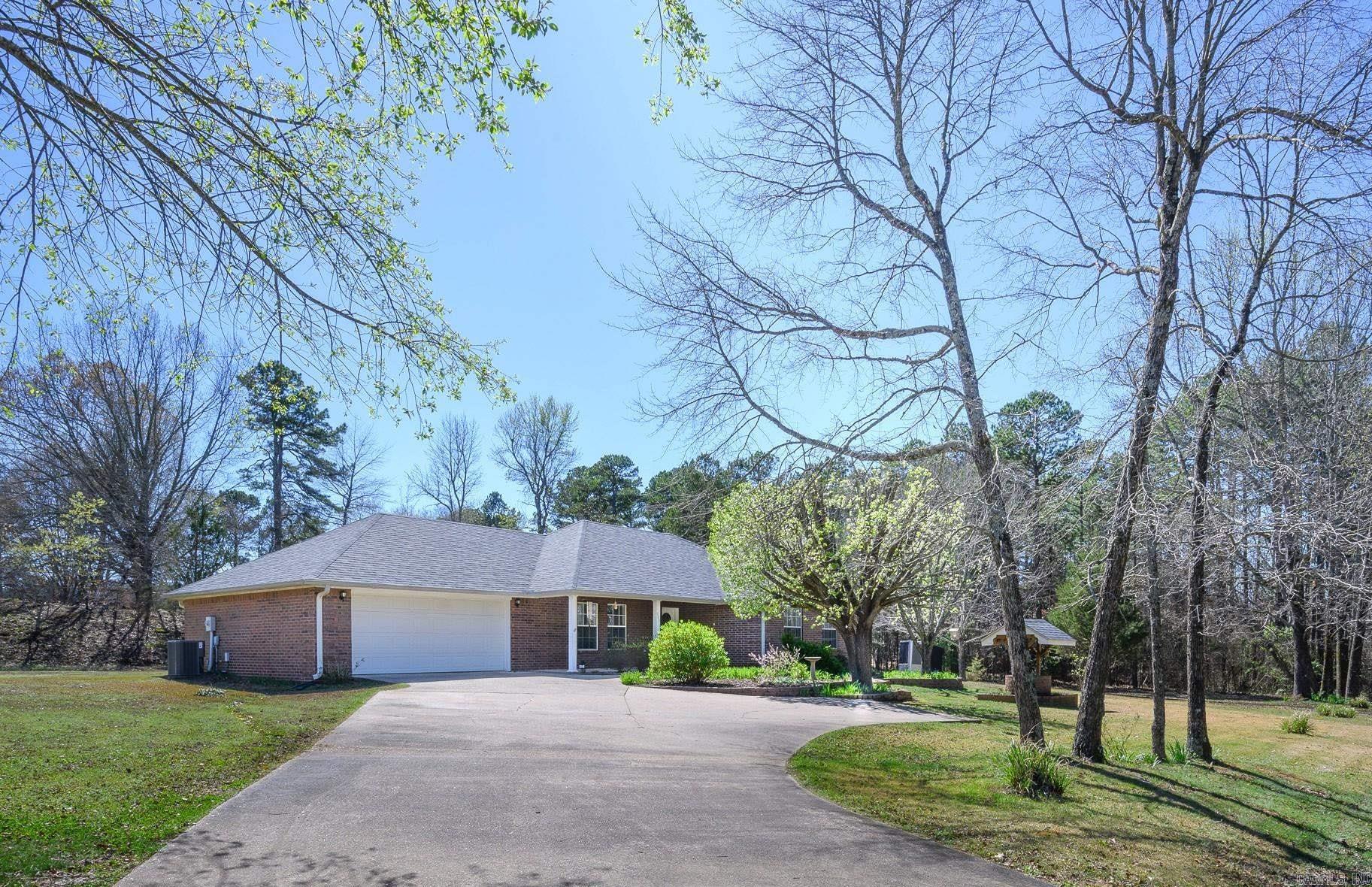 This is it! This beautiful 3-bed, 2.5-bath brick home sits on 1 acre on a quiet cul-de-sac, offering plenty of space to enjoy. Inside, the home features upgraded touches like the vaulted ceilings in the living room & one of the guest bedrooms, creating a bright & open feel. The spacious master suite includes a tray ceiling, large closet, & a relaxing bathroom w/ a jetted tub. All bedrooms offer generous closet space. The dining area features patio doors that open to the backyard patio & in-ground swimming pool—perfect for entertaining or relaxing during warm Arkansas summers. The pool area is surrounded by a privacy fence & includes a new pool cover installed last year. Additional highlights include a 2-car garage, a nice concrete driveway, & a 26x30 shop that provides excellent space for hobbies, storage, or extra vehicles. The front yard features extra landscaping that adds to the home’s curb appeal. A new roof was installed in 2024. All appliances stay, making this home truly move-in ready. Located just minutes from the beautiful Ouachita National Forest & nearby ATV or MT bike trails, this property is ideal for outdoor enthusiasts who want comfort at home & adventure close by.