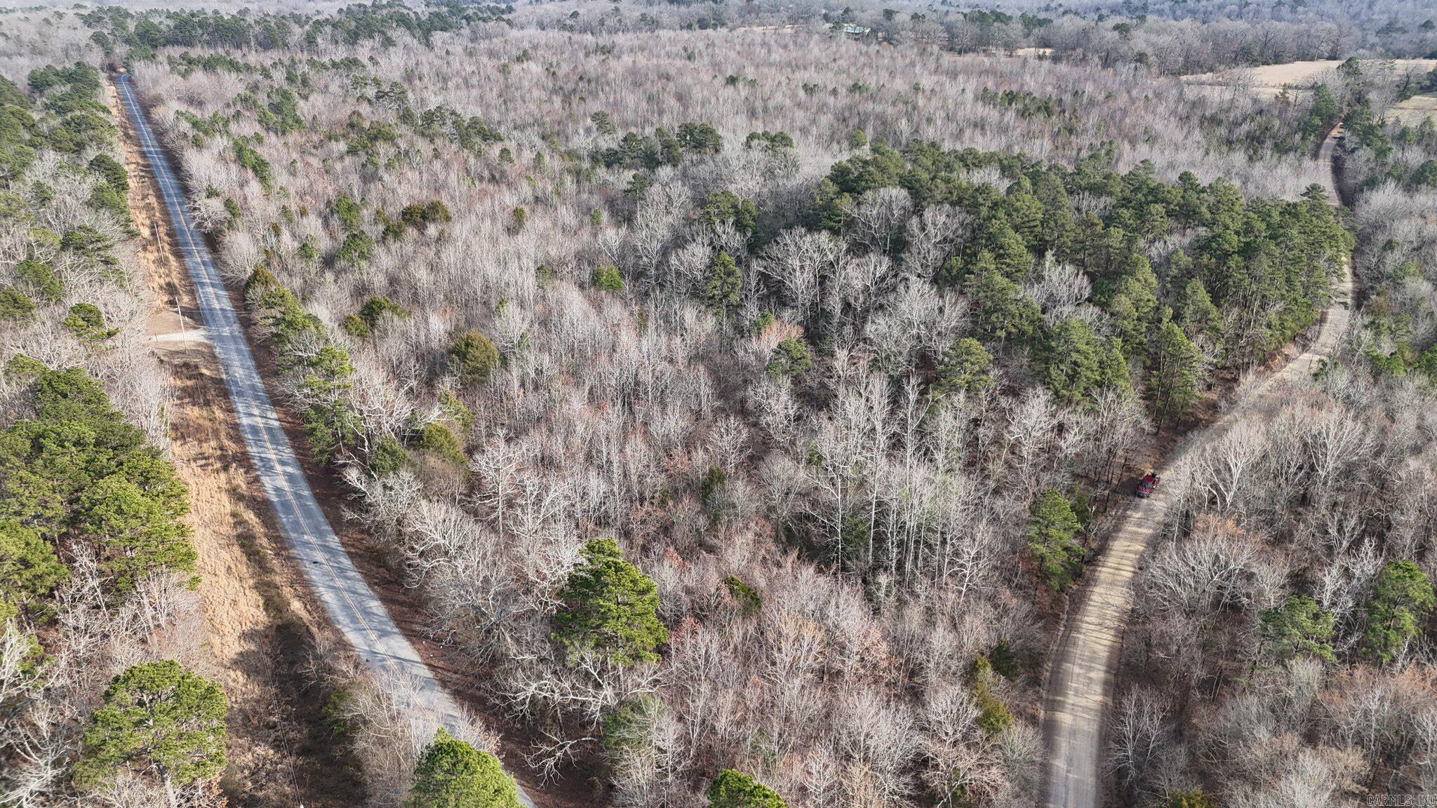 66.26-acre tract at the corner of Polk Road 95 and 48 in the Mena area, offering a mix of rolling wooded acreage with mature hardwoods, a seasonal creek, and abundant local wildlife. The property lends itself to hunting, recreation, or a future homesite, with multiple private building areas and room for trails or cabin sites. The Ouachita National Forest is approximately a quarter mile down Polk 48, providing convenient access to additional trails, hunting areas, and outdoor activities, subject to buyer verification of access and any use restrictions. This tract combines privacy, natural beauty, and proximity to town, making it a strong option for those seeking Arkansas country land near Mena; buyers should verify acreage, utilities, access, and intended uses with the appropriate authorities.