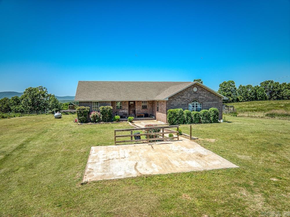 Escape to the Ozarks with this beautiful 2,400 sq. ft. brick home on lush, fenced pastureland just minutes from the Buffalo National River at Grinders Ferry. Featuring hardwood floors, vaulted ceilings, abundant natural light, and an open-concept kitchen, dining, and living area built for comfortable country living. The split floor plan offers privacy with spacious guest bedrooms and a large master suite complete with an oversized closet and relaxing corner tub. A huge family room provides extra space for gatherings and entertaining. Outside, enjoy peaceful views from the covered back deck overlooking gently rolling pasture perfect for livestock, horses, gardening, hunting, or a hobby farm. With cross-fenced acreage and no restrictions, this property offers the ideal setup for a rural homestead, recreational retreat, or full-time country lifestyle in one of Arkansas’ most desirable areas.