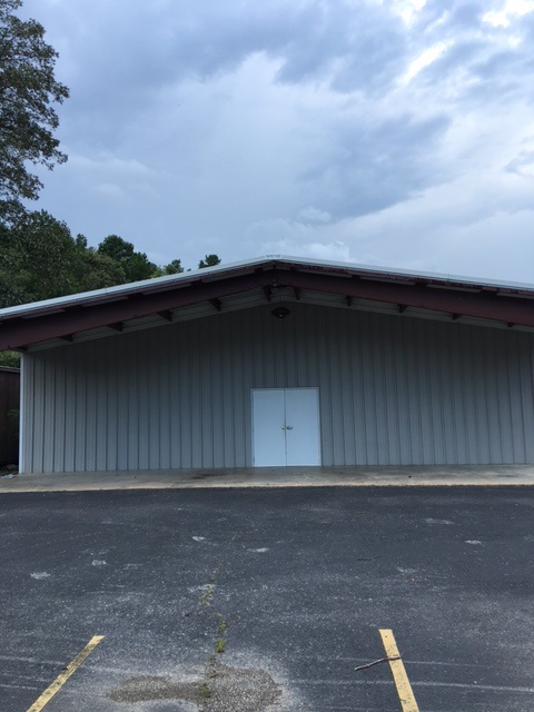 Multiuse property. 3000 sq ft metal building sits on 2.03 acres, small lift station shared with neighboring property. Large parking area, easy access. Owned by bank, call listing agent for details.