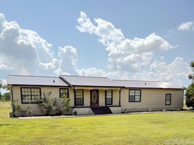 Enjoy peaceful rural living in this spacious 3-bedroom, 2-bath home situated on approximately an acre of land.  This property offers a great blend of comfort and functionality, featuring two versatile outbuildings, an attached garage, and ample outdoor space.  A new roof has been installed, along with new siding on the exterior, giving the home a fresh new look.  Do not miss this opportunity to own a home with plenty of room to grow.  *The single-wide trailer is not included in this list price.*