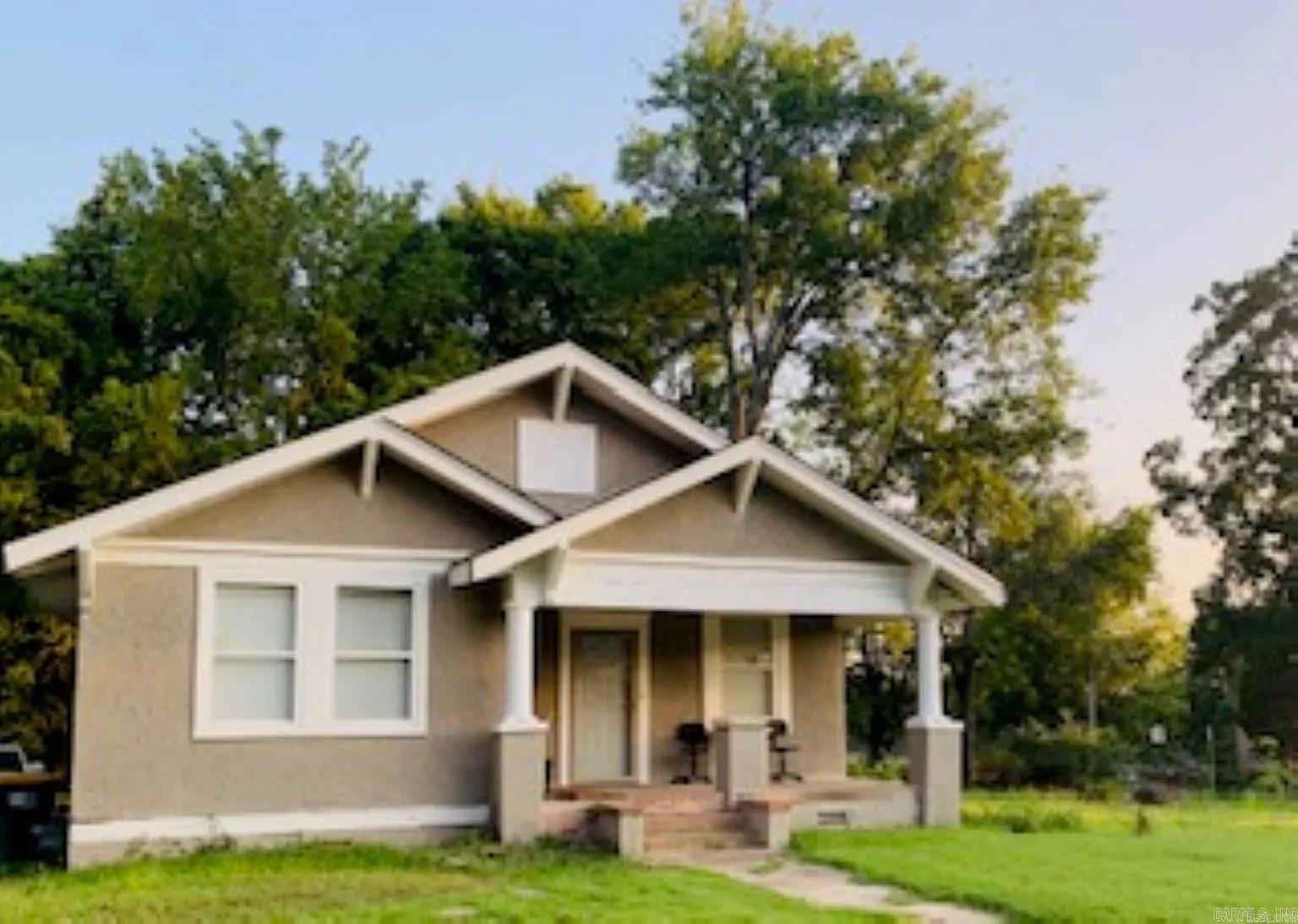 Welcome to 3817 W 10th Street in the Forest Hill subdivision — a classic bungalow full of character and charm in the heart of Little Rock.  Great Investment Property!  Built in 1930, this one-story home offers approximately 991 square feet with 2 bedrooms and 1 full bath, all on the same level. The stucco exterior and welcoming front porch create timeless curb appeal, while inside you’ll find a kitchen/dining combo and a decorative fireplace that adds vintage charm to the living space. The layout offers a cozy, functional flow ready for your personal style and updates.  Situated on a level 0.14-acre lot, the property includes parking pads and convenient access to public utilities. Its central location provides easy access to nearby amenities while still maintaining a neighborhood feel.  If you appreciate classic architecture and are looking for a home with character and potential, this one is worth a closer look. Schedule your showing and imagine the possibilities.