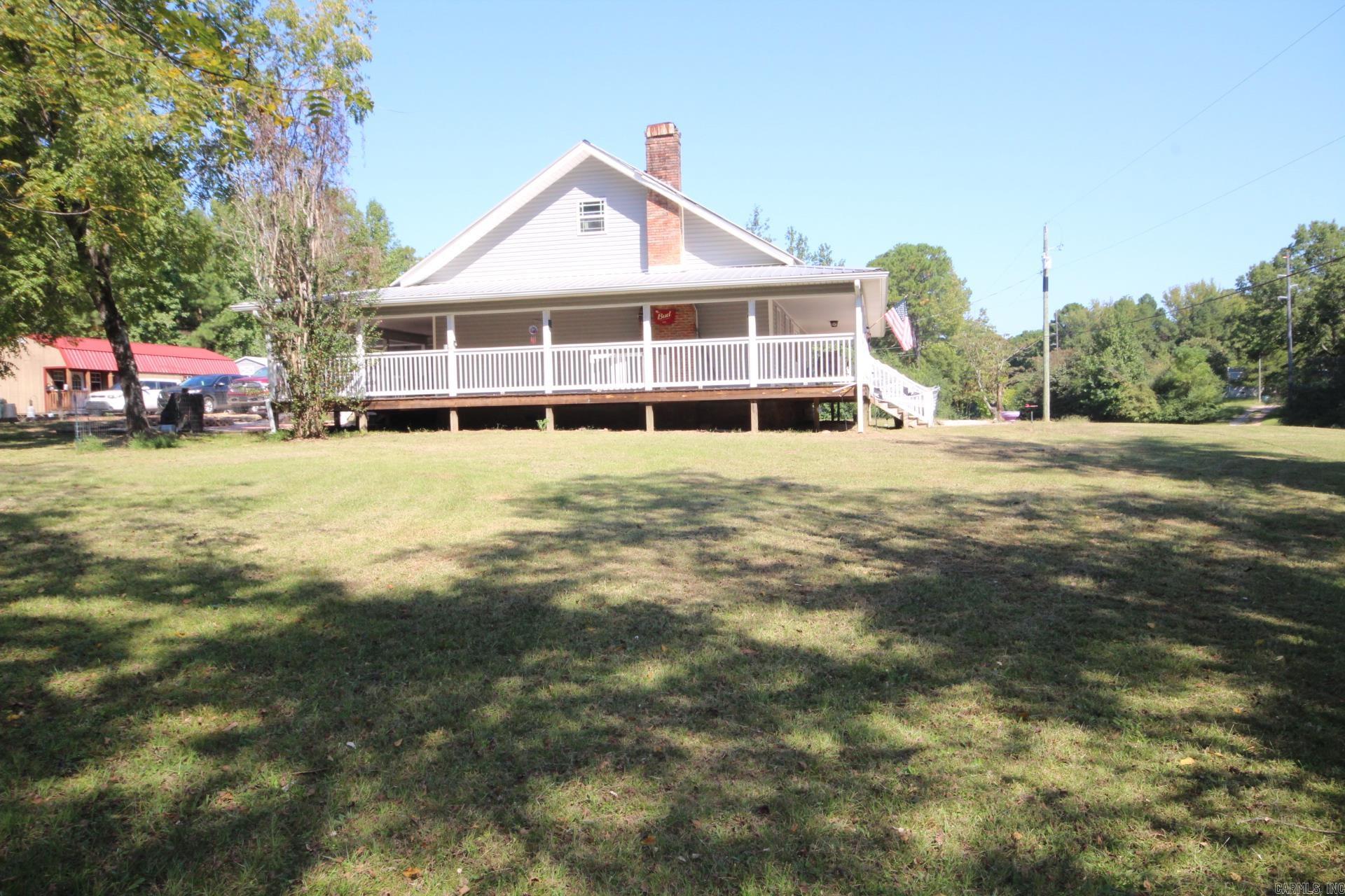 JUST A SHORT DISTANCE TO CRATER OF DIAMONDS STATE PARK, LAKE GREESON AND LITTLE MISSOURI RIVER. 3 bedrooms, 2.5 baths with approx. 2512 Sq. Ft. of livings space.  Kitchen is spacious with lots of cabinets, concrete counter top and a wood epoxy Island. Large living area, and a large upstairs bonus room.   Home features a covered wrap-around porch.  Central A/C & Heat.  Metal Roof. Range, refrigerator and washer/dryer conveys with sell of home. Property has a storm shelter, two outbuildings and pond.