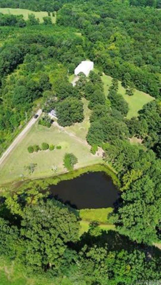 This beautiful 40-acre property is a must see! The private setting and comfortable home provides a peaceful retreat with a stocked pond and ample room for gardening or raising hobby farm animals. A standout feature is the impressive 50' x 100' commercial-grade shop, designed to accommodate a wide variety of businesses and commercial uses. Built with 12x12 footings and approximately 5-inch concrete floors. The shop also features four 16' x 16' overhead doors, and a loading dock, providing access for large equipment, RVs, heavy machinery, or deliveries for contractors, mechanics, manufacturing, agricultural operations, or entrepreneurs looking to operate their business from home. Schedule your private showing today and discover everything this remarkable property has to offer!