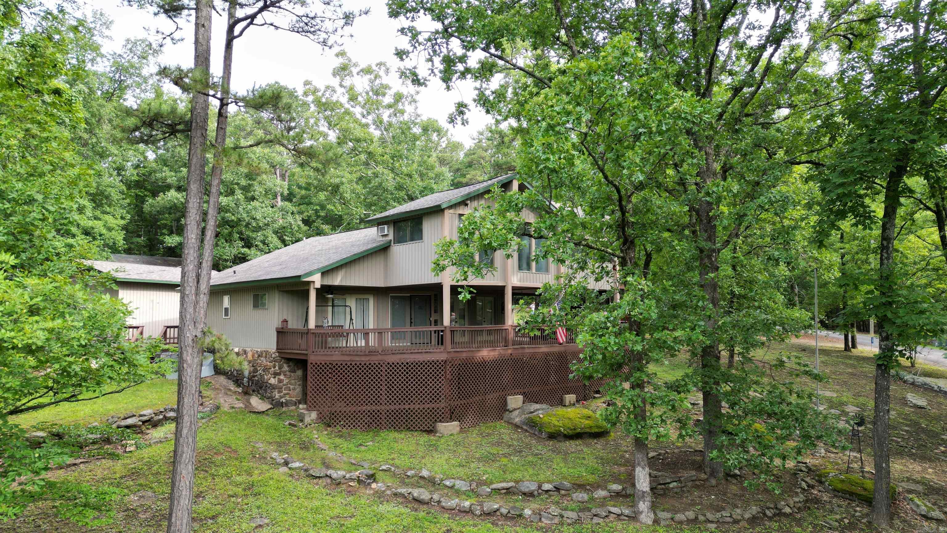 Welcome to lake living in beautiful Tumbling Shoals on Greers Ferry Lake. This 3 bedroom, 2 bath home sits on 1 acre directly across the street from the lake and offers private access to a boat ramp for endless days on the water and is located just minutes away from Dam Site Marina. Enjoy peaceful lake views from the oversized front deck that stretches across the home where you will find the perfect place to relax, entertain or unwind after a day of boating and fishing. Property includes a shop for space to store your boats and lake toys and parking for family and guests. Whether you are searching for a full-time residence, vacation getaway, or investment opportunity, this home offers the perfect setup. Roof was replaced in 2023. All offers are welcomed! Agents see remarks.