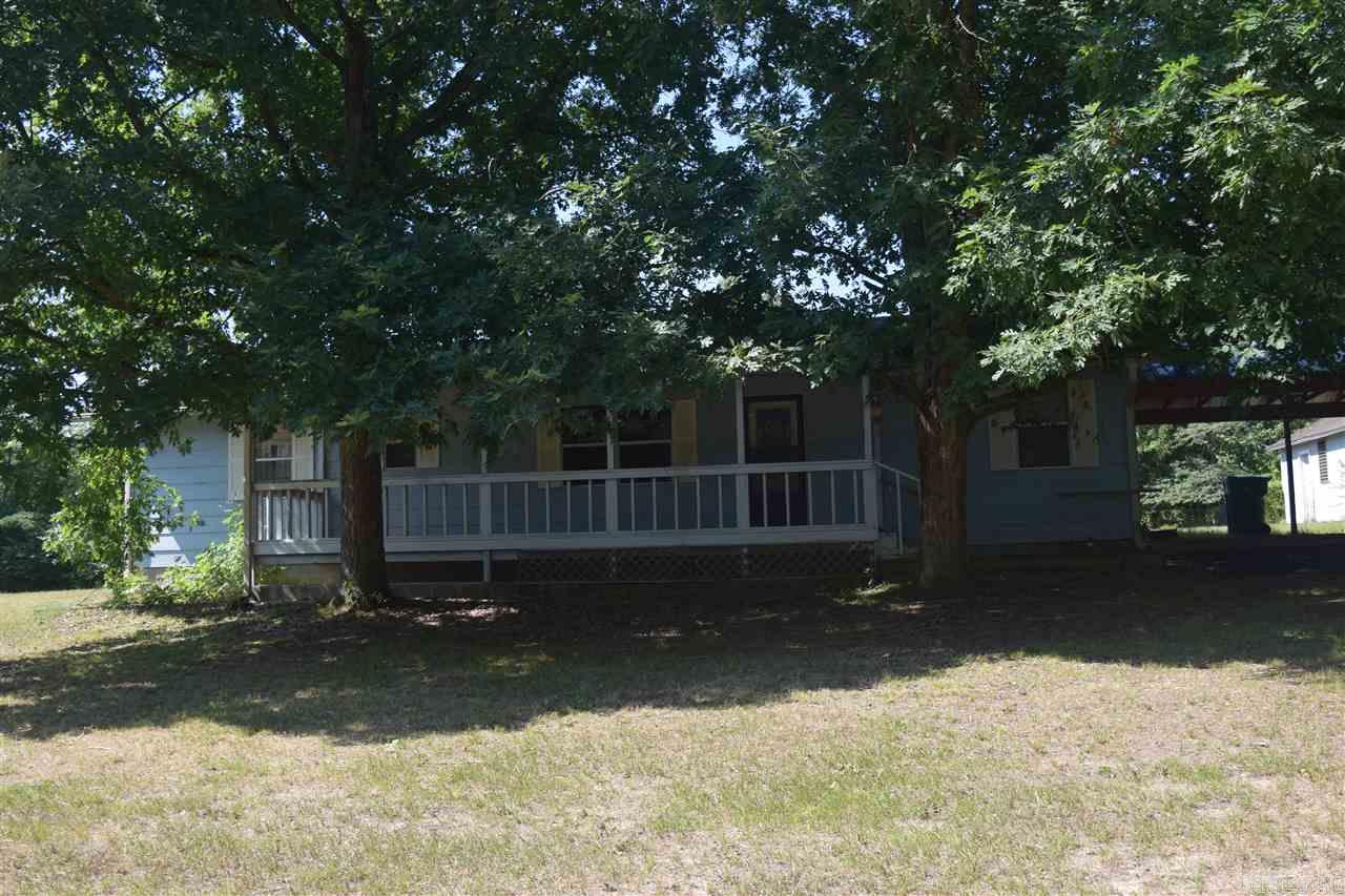 Enjoy the 8' x 30' covered front porch looking over rolling pasture and a small pond. Long driveway from the road allows privacy & tranquility. 2.84 acres that is fenced. Over-sized two car garage - 720 square feet work bench, power & overhead storage. Home has a large living room that is open into the dining area off the kitchen. Large laundry/utility room. 3 bedrooms, 1 bathroom. One car carport. Extra outbuilding with power - 384 square feet. Qualifies for 100% USDA Rural Development Financing.