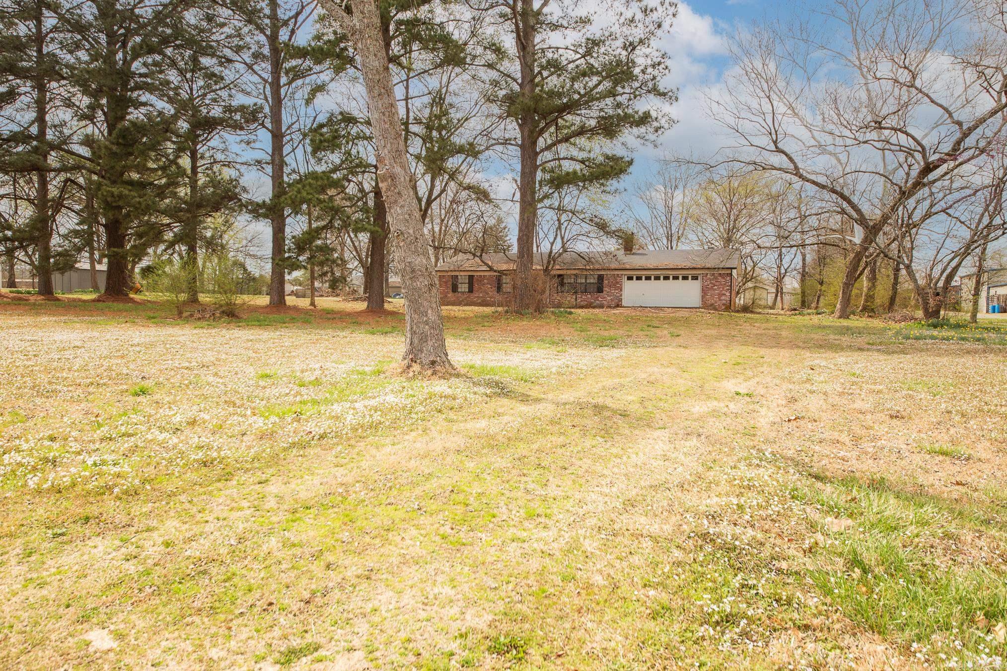 Great commercial potential!  1.5 AC Zoned C-2. Great location for fast food, retail or service. High traffic count. House could be remodeled for business if needed. All brick home on slab. 1247 sq ft with 2 car garage built in 1987. Call for more details.