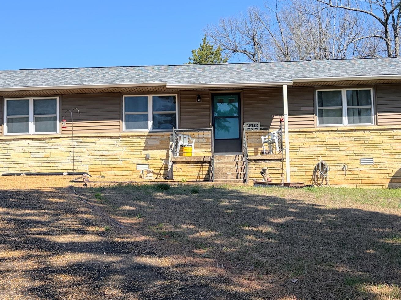 Want to feel like your King or Queen of the hill? You can with this 3-bedroom 2 bath cottage home. This cutie is perched up on a hill on a corner lot. Off the kitchen is an all-season room, which could be used for a den or dining room or craft room/ home office. Plenty of natural sunlight in this room. This home has many upgrades from a new kitchen sink, all new plumbing under the kitchen sink, a garbage disposal, water filtration system under the kitchen sink, all new plumbing under bathroom sinks, the washer/ dryer combo is a hybrid and energy compliant, the hot water tank is also a hybrid and energy compliant working off the heat pump, and the gutters all drain underground away from the house. This home has smart features from the thermostat to the hot water tank to the washer/dryer. There's a 1 car garage but plenty of parking outside on the driveway. A shed out back. The roof is about 2 years old, and the HVAC system is bout 4. Just a few short blocks from the golf course and downtown.  This home comes fully furnished. Just bring your toothbrush. Are you ready to feel like your king/queen of the hill? Call today to see this cutie.