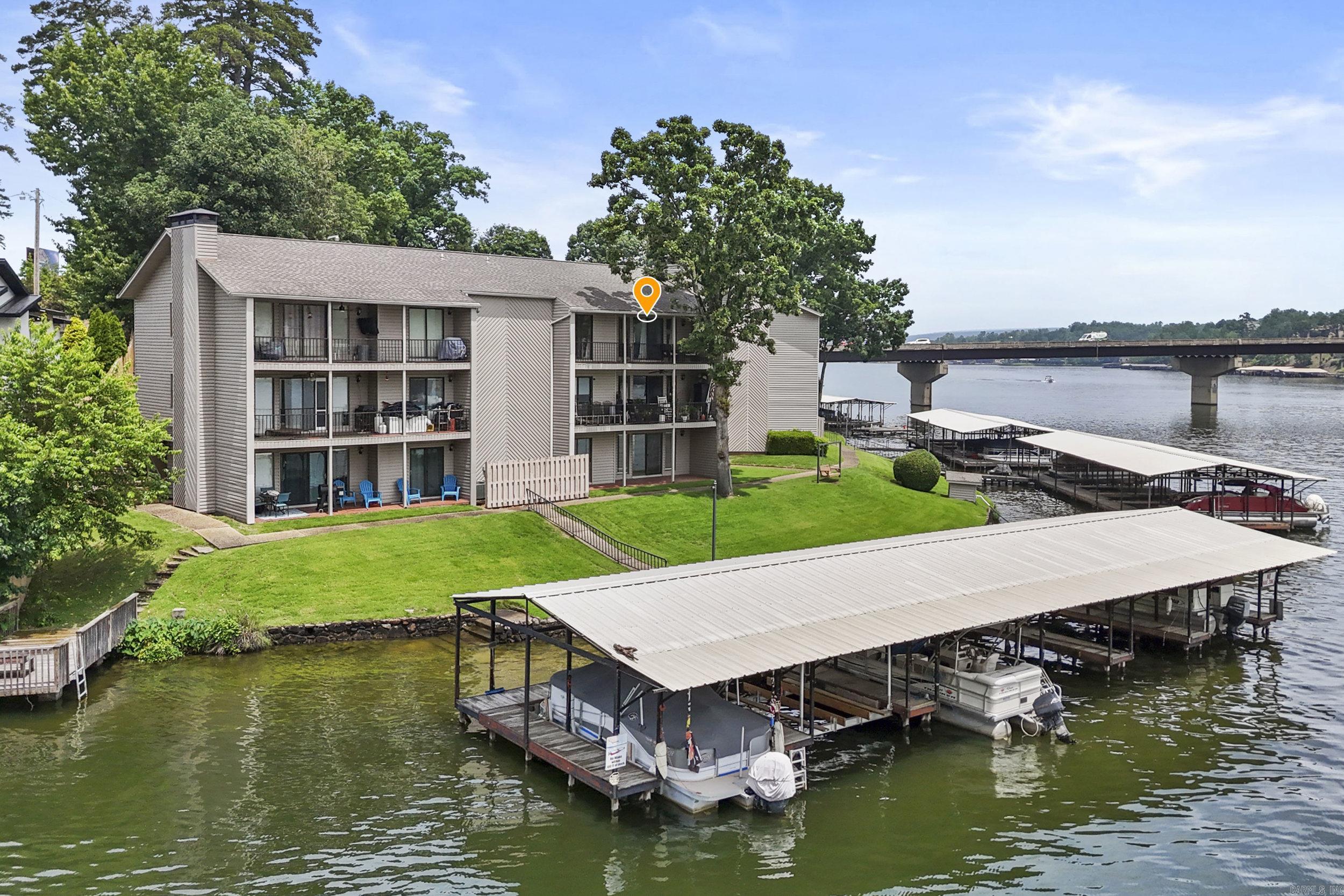 Stunning Lake Hamilton Waterfront Condo~Boat Slip Included~Furnished~STR Approved !!Exceptional opportunity to own a beautiful lakefront condo on stunning Lake Hamilton! Beautifully Furnished with Sleek & Modern Furniture & Finishes; This well-maintained and updated 2-bedroom, 2-bath condo offers breathtaking lake views from almost every room and includes a private boat slip for easy access to the water. The Main Living area featues an Open Living Space for easy entertaining, Fireplace, Gorgeous Granite Kitchen Countertops & Breakfast Area & Bar! Enjoy resort-style amenities in this gated complex, including a swimming pool and beautifully maintained grounds. Conveniently located near Oaklawn Racing Casino Resort, Historic bath house row, restaurants, shopping, and all the attractions that make Hot Springs a premier destination. Whether you're looking for a full-time residence, vacation getaway, or income-producing property, this condo is Turn-Key & an outstanding investment opportunity. Short-term rentals are allowed, making it ideal for maximizing rental potential while enjoying all that lakefront living has to offer. Check out the Video!!!