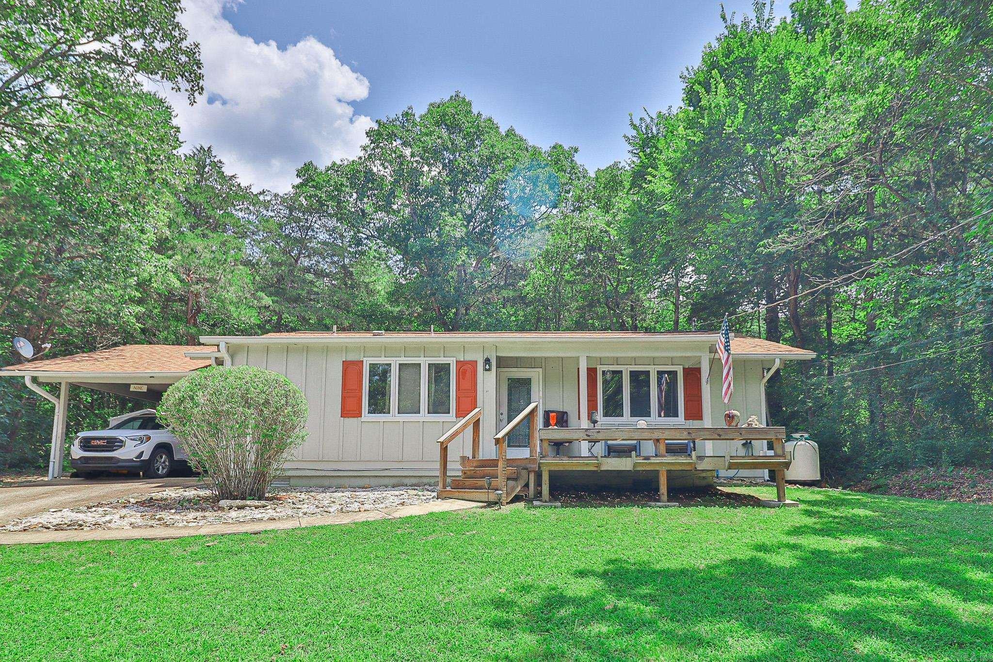 Tucked away on a secluded lot in Cherokee Village, this 3 bedroom, 2 bath home offers a comfortable setting with plenty of charm. The home features a cozy living area with a gas log fireplace, a functional kitchen with generous pantry space, and ample closet storage throughout. Enjoy the peaceful setting from the front deck, or take advantage of the covered carport for convenient parking. A new roof was installed in 2024, adding extra peace of mind. Located near the lakes and amenities of Cherokee Village, 9 Tonto Circle is a great option for a primary residence, weekend getaway, or investment property.