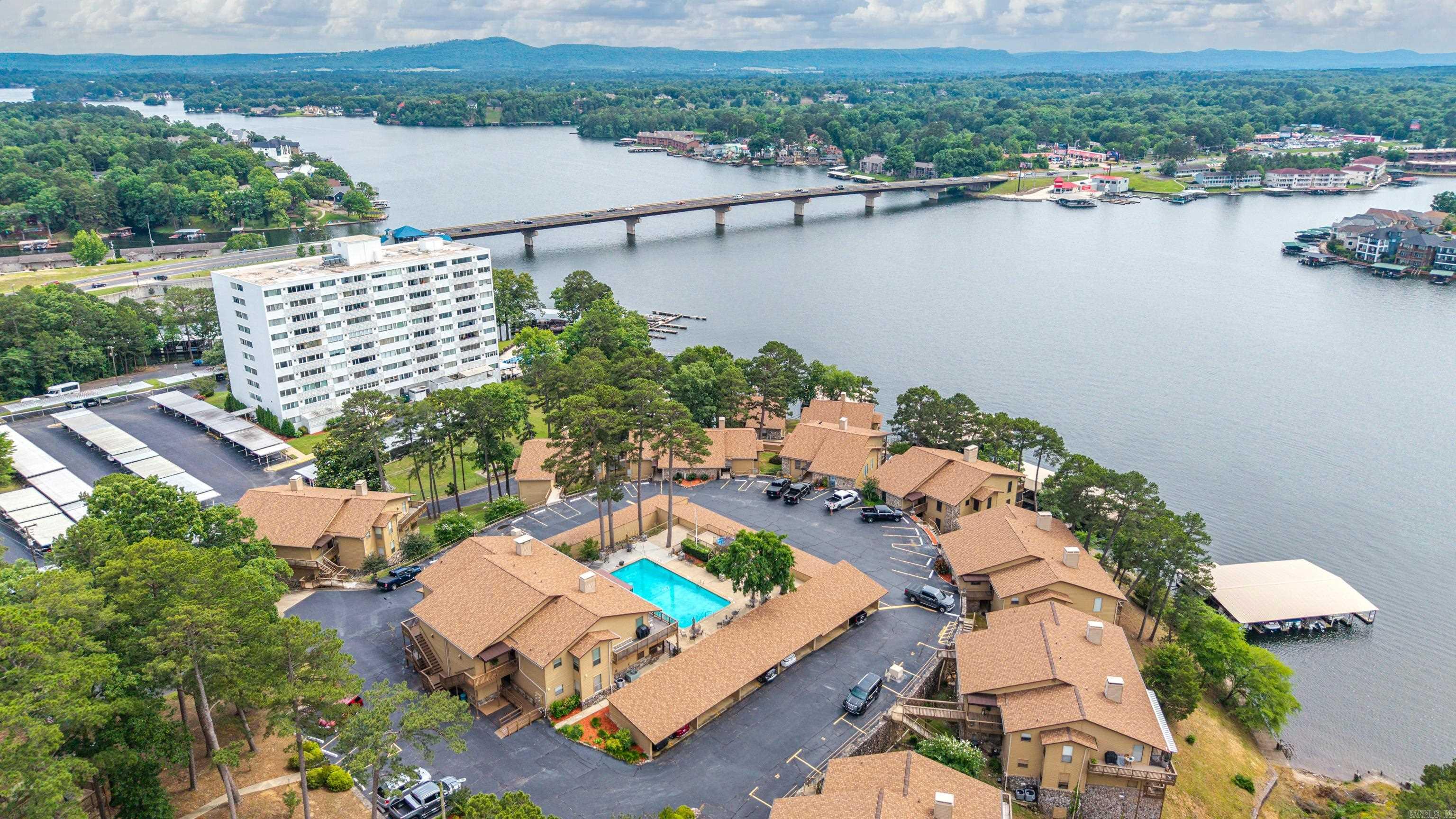 Experience luxury lake living in this stunning fully furnished 3-bedroom, 2.5-bath waterfront condo offering panoramic views of the main channel. Designed for both relaxation and entertaining, this beautifully positioned property features TWO private boat slips, a two-car carport, and an exterior storage unit for added convenience. Enjoy breathtaking water views from multiple living spaces while being just steps away from the lake. POA covers: Trash, Water, lawn care, outside maintenance, and Natural Gas. Please note, short term rentals are not permitted, creating a more peaceful and private atmosphere, however 6month minimum rentals are allowed. This is an incredible opportunity to own a low-maintenance lakefront retreat with premium amenities and unbeatable views.