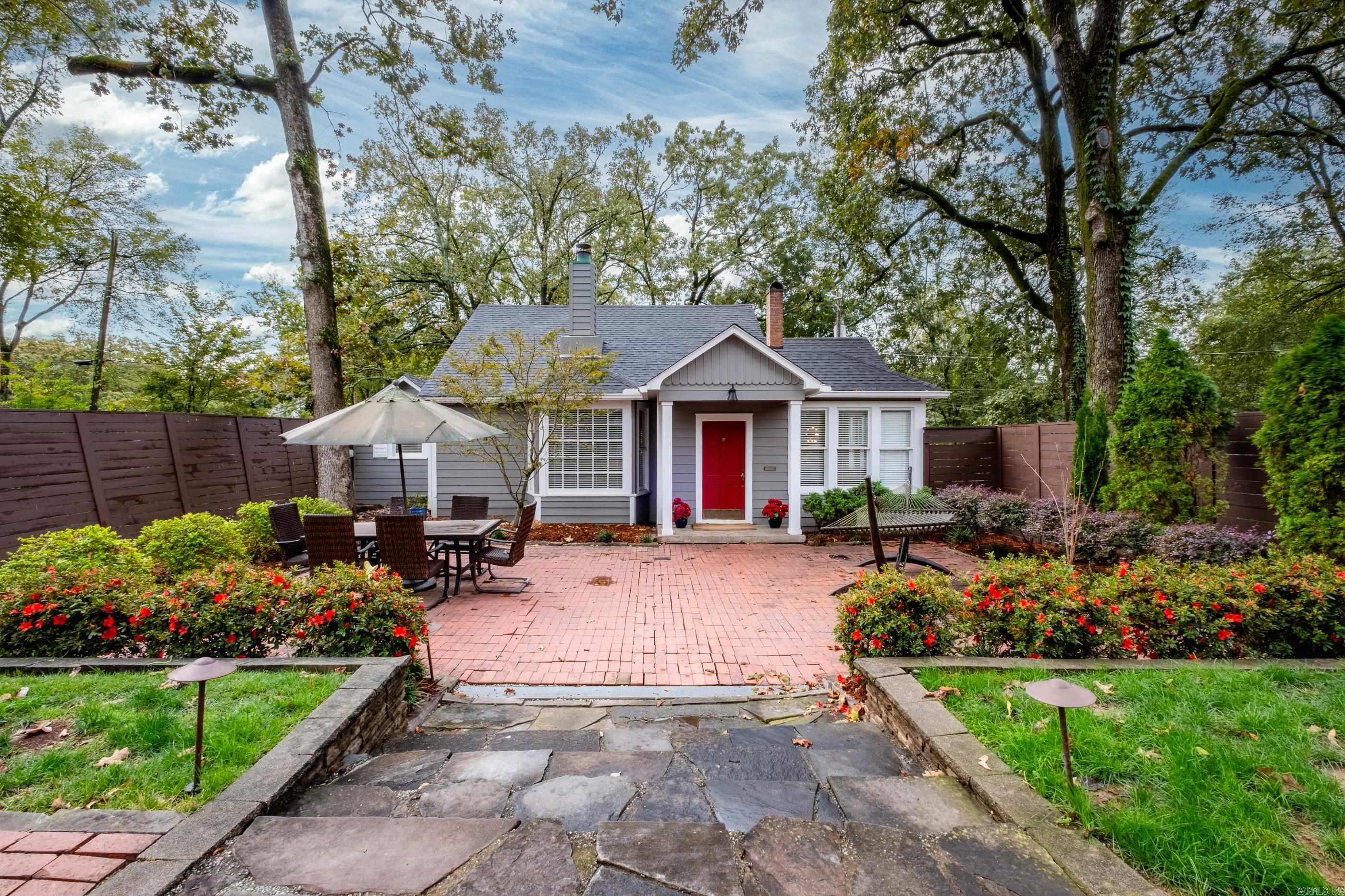 Beautifully updated Hillcrest bungalow featuring a main-level primary suite with an extensive walk-in closet and a stylishly renovated bathroom. The updated kitchen offers beautiful finishes and modern functionality. Upstairs, you’ll find an additional bedroom with its own ensuite bath. Enjoy the serenity of the spacious, fully fenced front yard with mature trees and lush landscaping—perfect for relaxing or entertaining. Covered parking adds extra convenience to this move-in-ready home in one of Little Rock’s most sought-after neighborhoods.